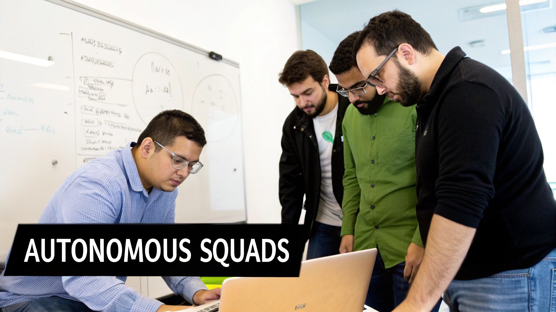 Four men collaborate around a laptop in an office, symbolizing an autonomous software development team.