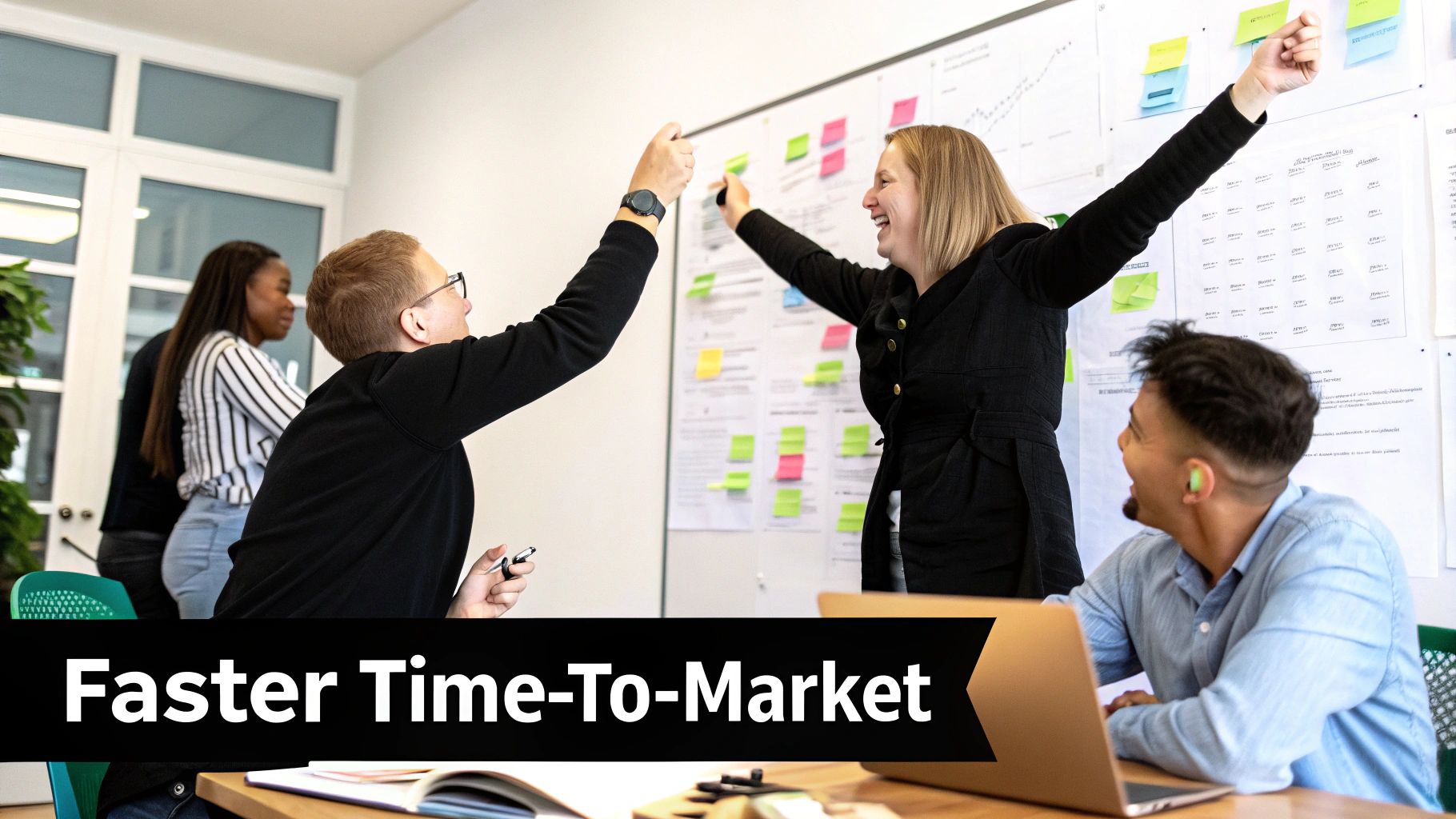 Diverse team collaborating enthusiastically on a whiteboard with sticky notes during a productive meeting.