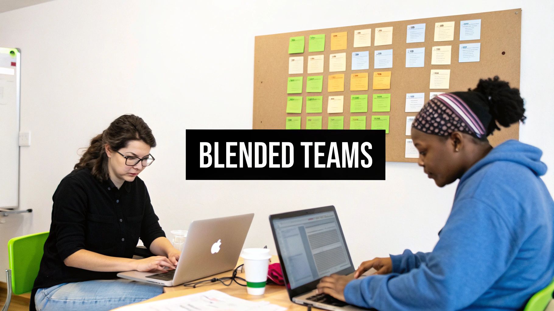 A project manager and a software developer working together on a computer screen, symbolizing modern team building.