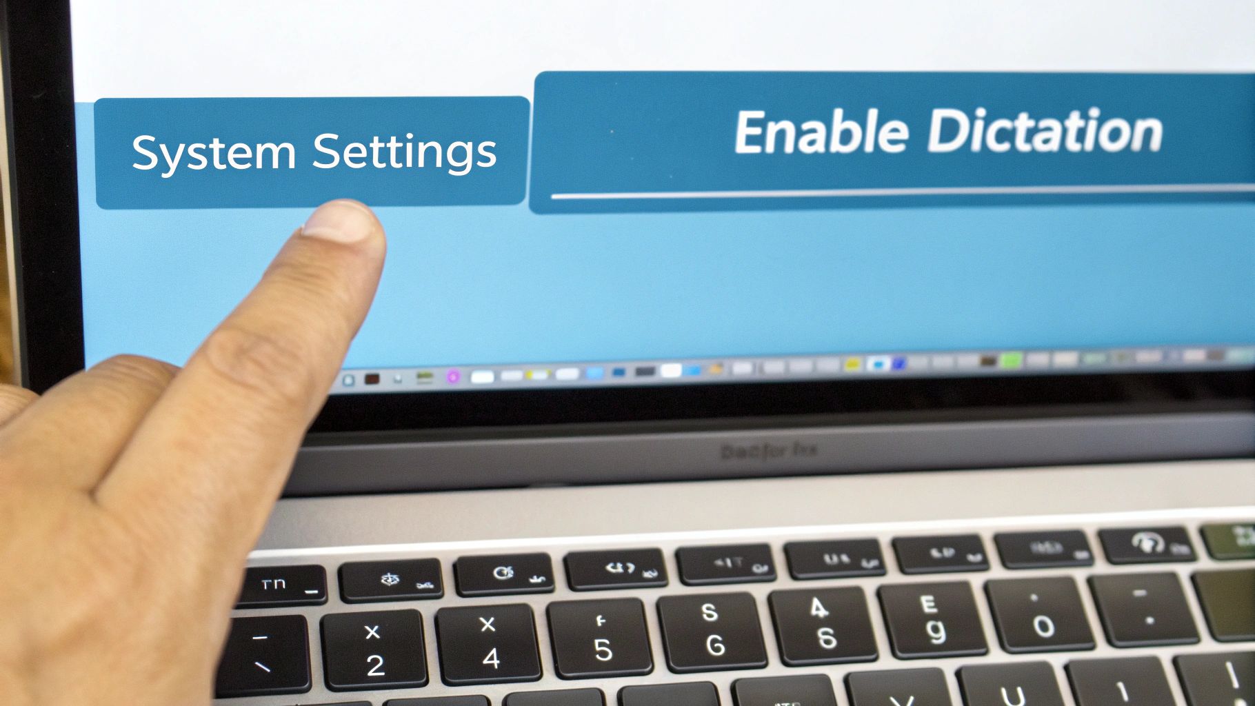 A finger touches 'System Settings' on a MacBook screen, with 'Enable Dictation' visible.