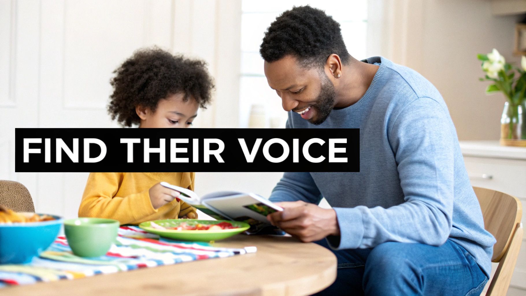 A child and a parent sitting on a floor, laughing while reading a book together.