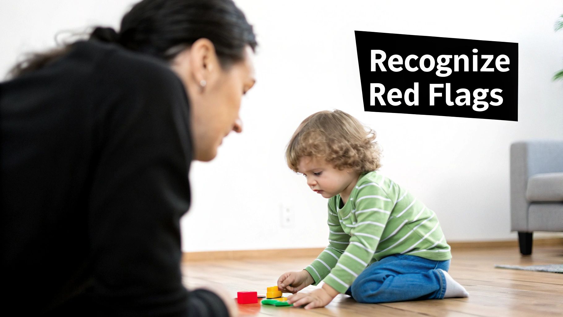 Finding a Pediatric Neurologist Dubai 2 A concerned parent looking at their child who is sitting on the floor playing with colourful blocks.