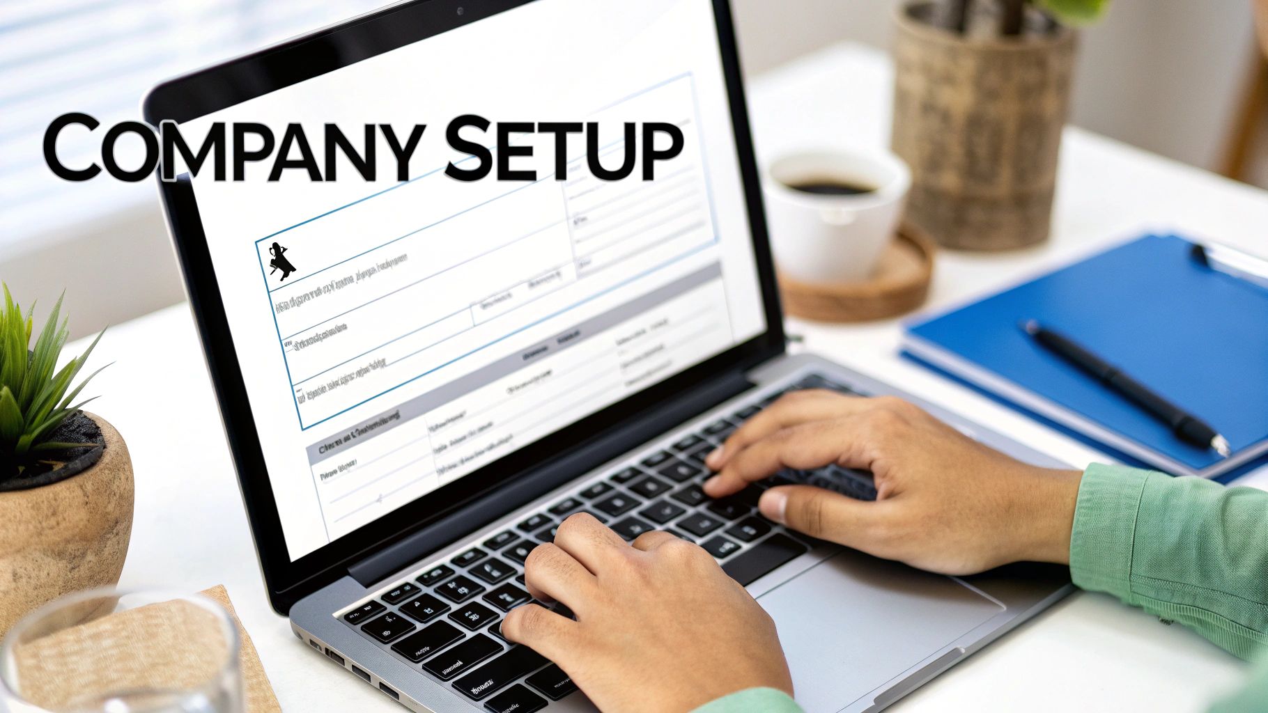 A person is typing on a laptop with 'COMPANY SETUP' text visible on the screen, indicating business registration.