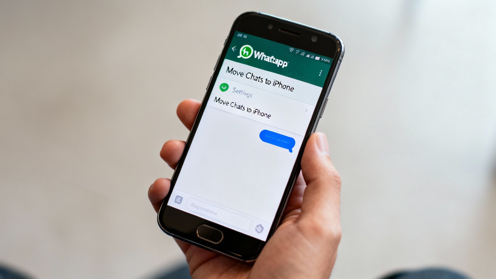 A hand holding a smartphone showing the WhatsApp 'Move Chats to iPhone' screen.
