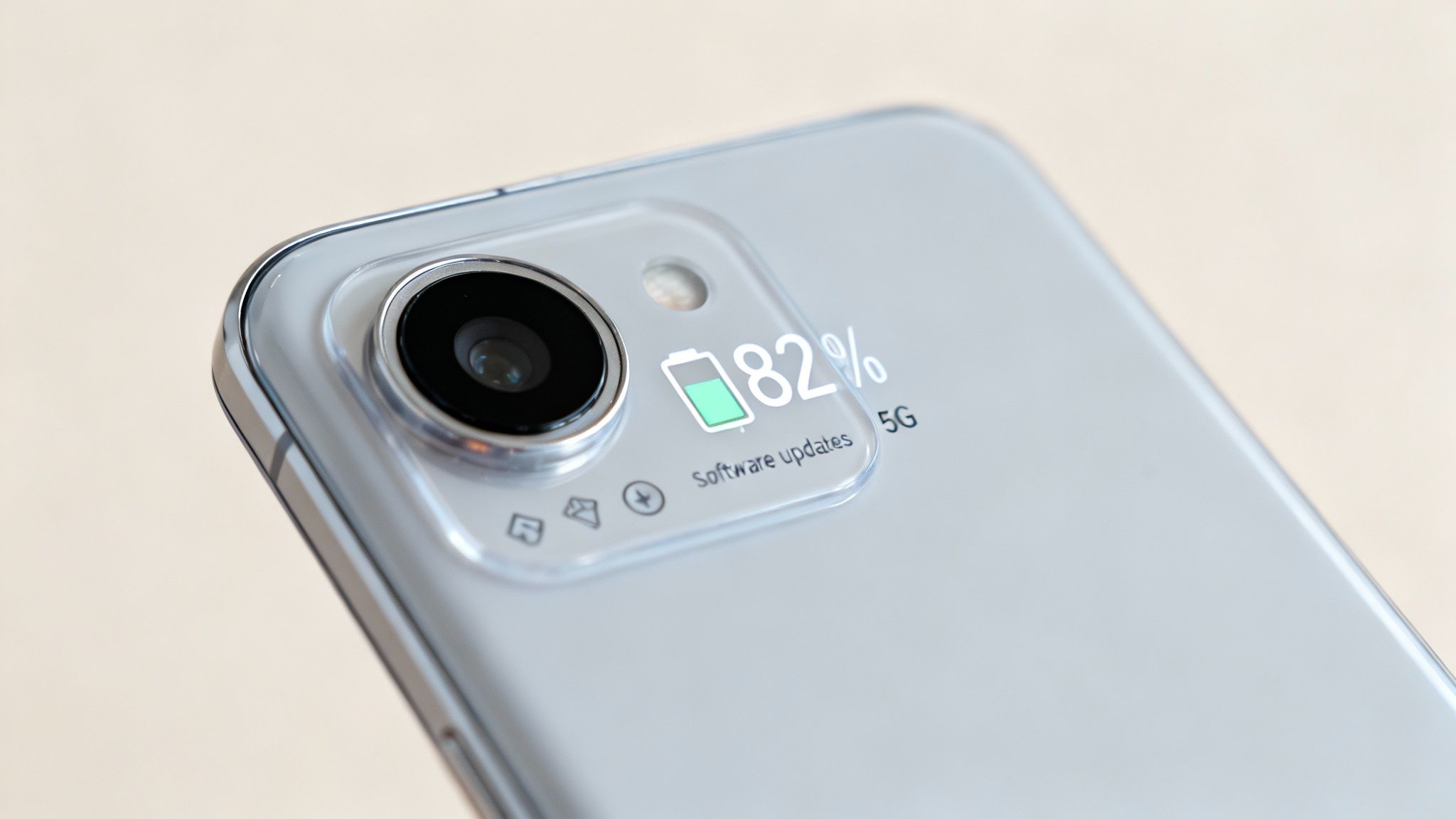 Close-up of a smartphone's back showing a camera, 82% battery, software updates, and 5G information.