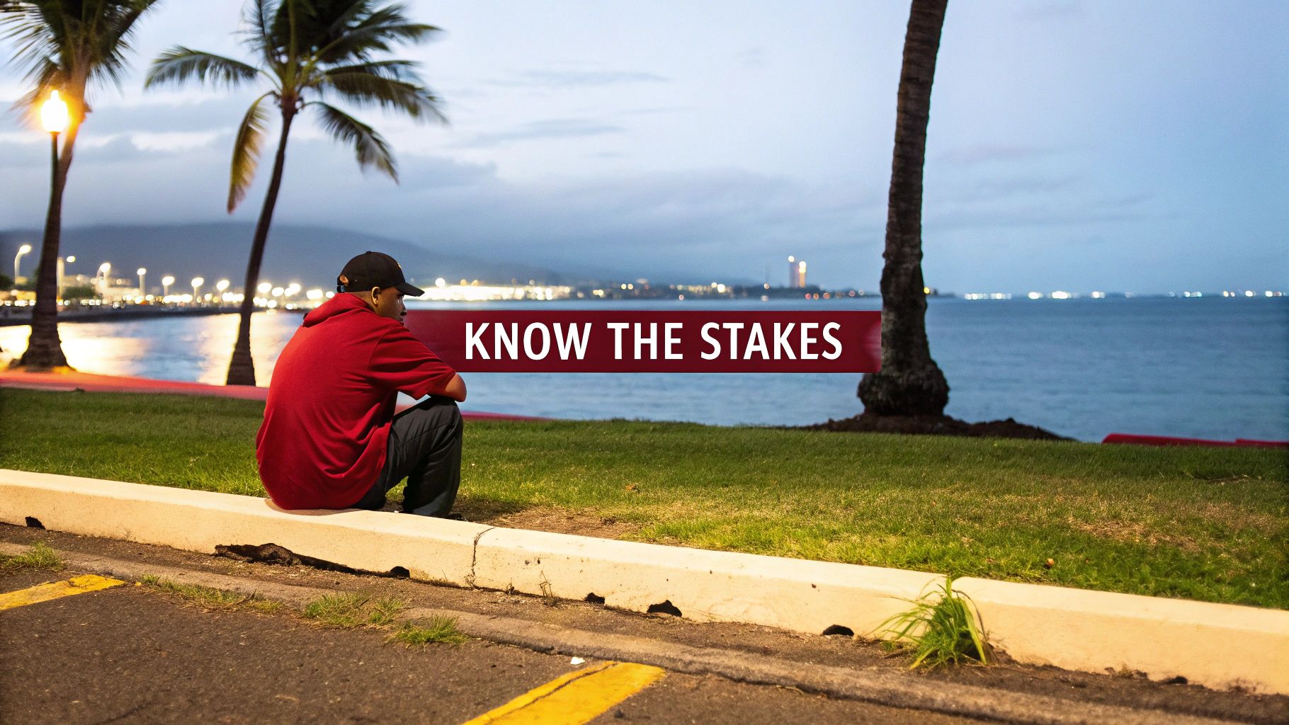 A person sits on a curb overlooking the ocean and city lights at dusk, with the text 'KNOW THE STAKES'.