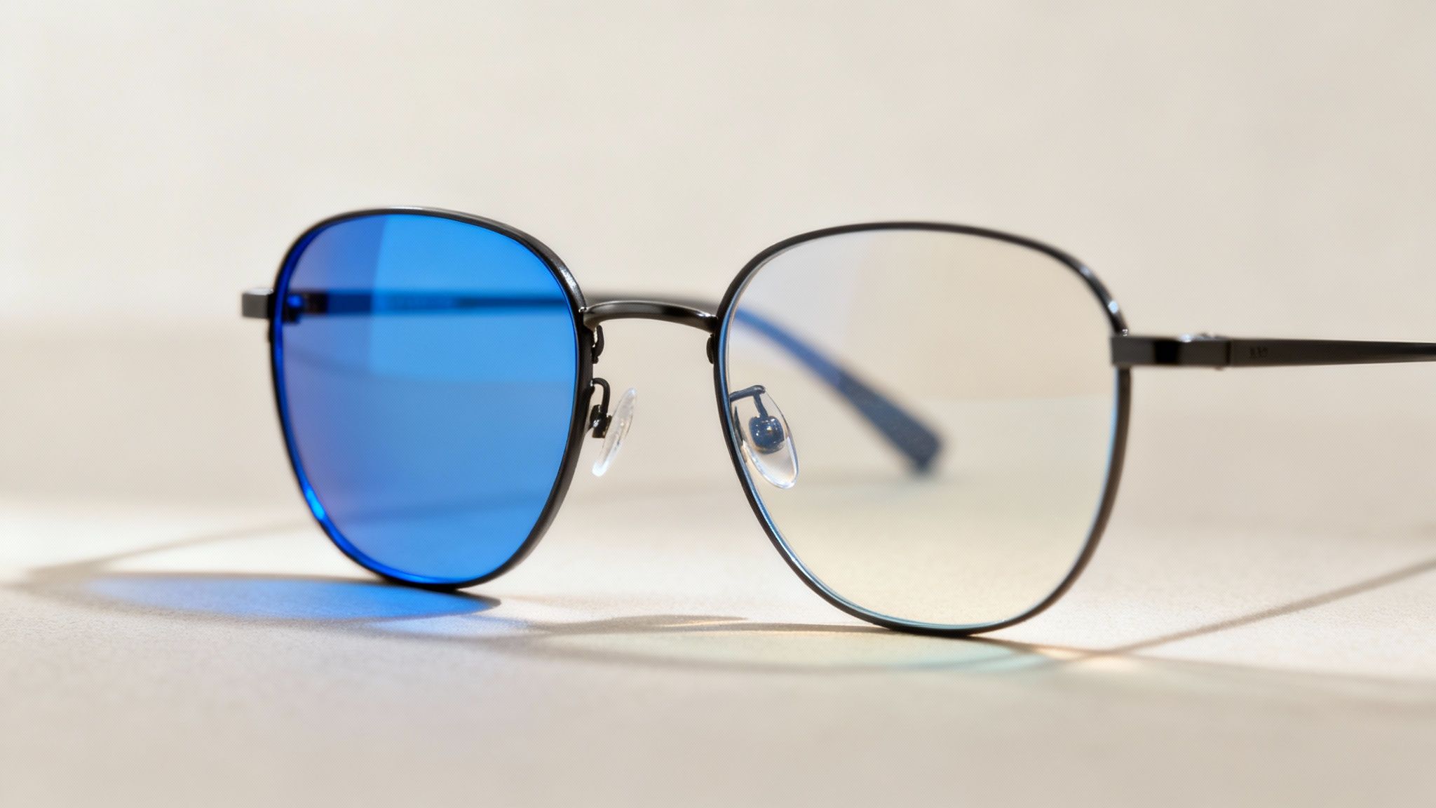 A close-up shot of an optometrist adjusting a pair of high-tech eyeglass lenses.