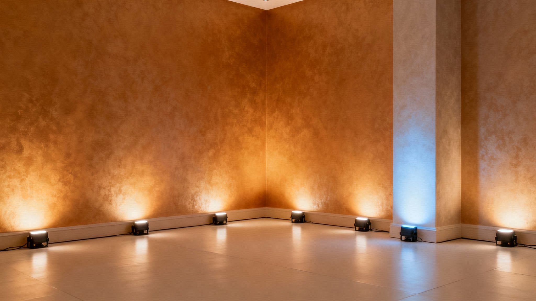 A grand event hall with purple LED uplights illuminating the columns and walls.