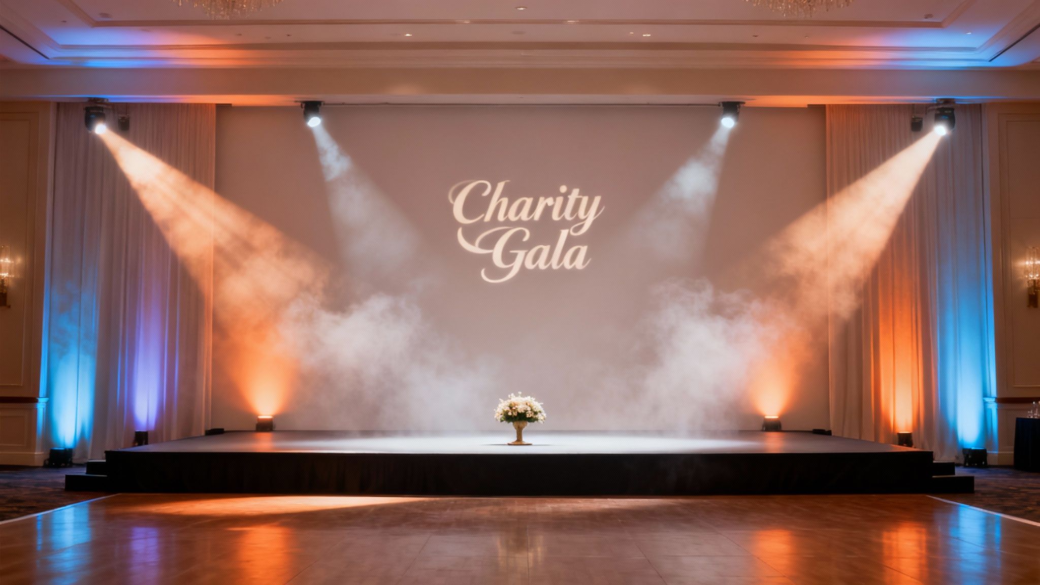 A brightly lit stage setup for a 'Charity Gala' event with spotlights, smoke, and a floral centerpiece.