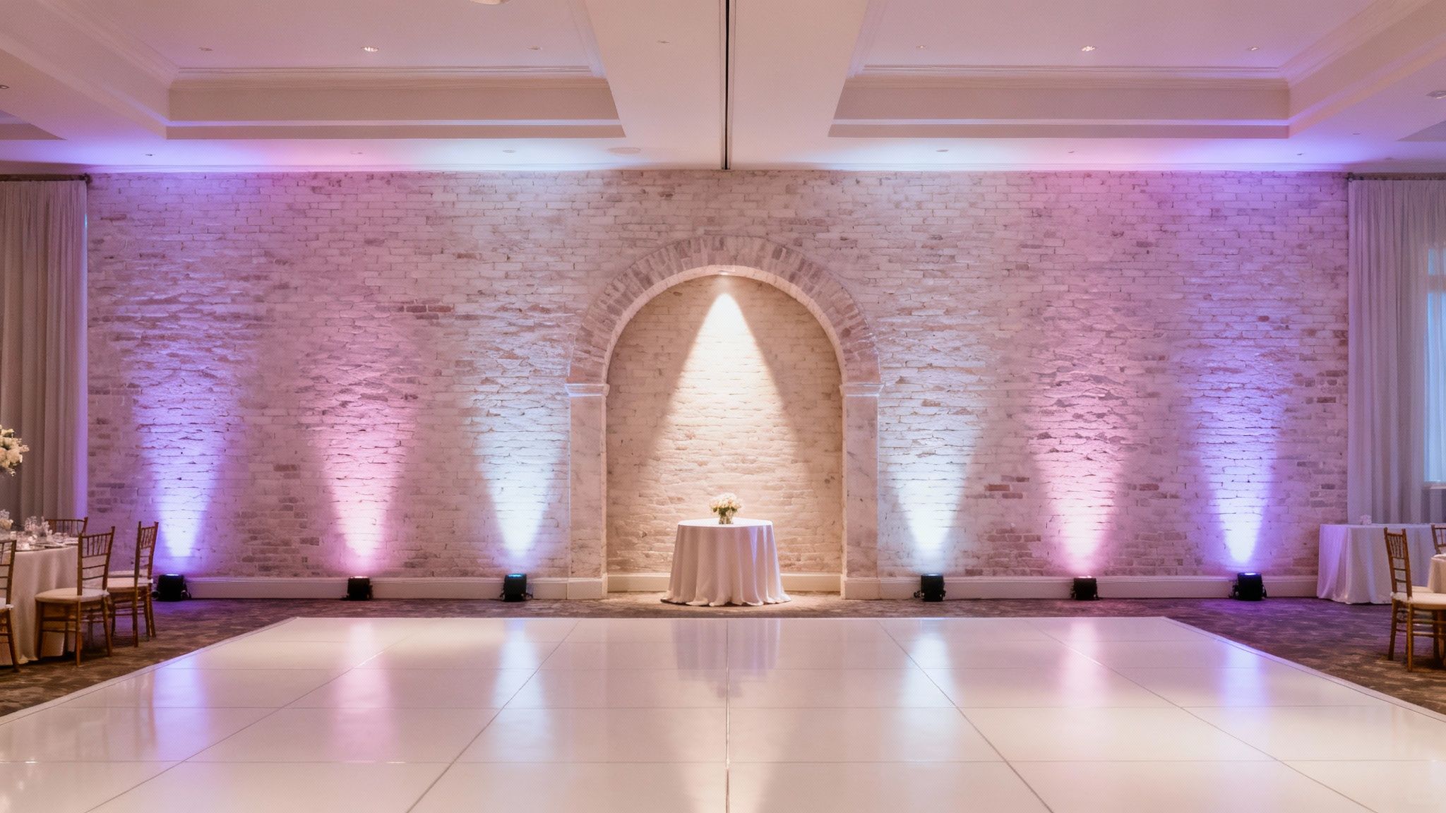 Bride and groom kissing with beautiful uplighting in the background