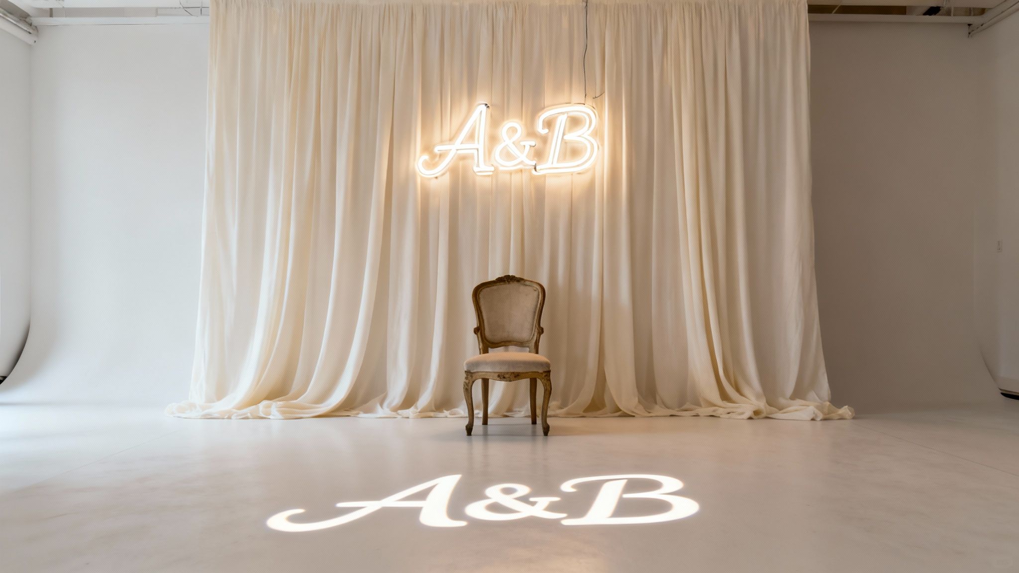 A studio setup with beige curtains, a vintage chair, and glowing 'A&B' neon sign and floor projection.