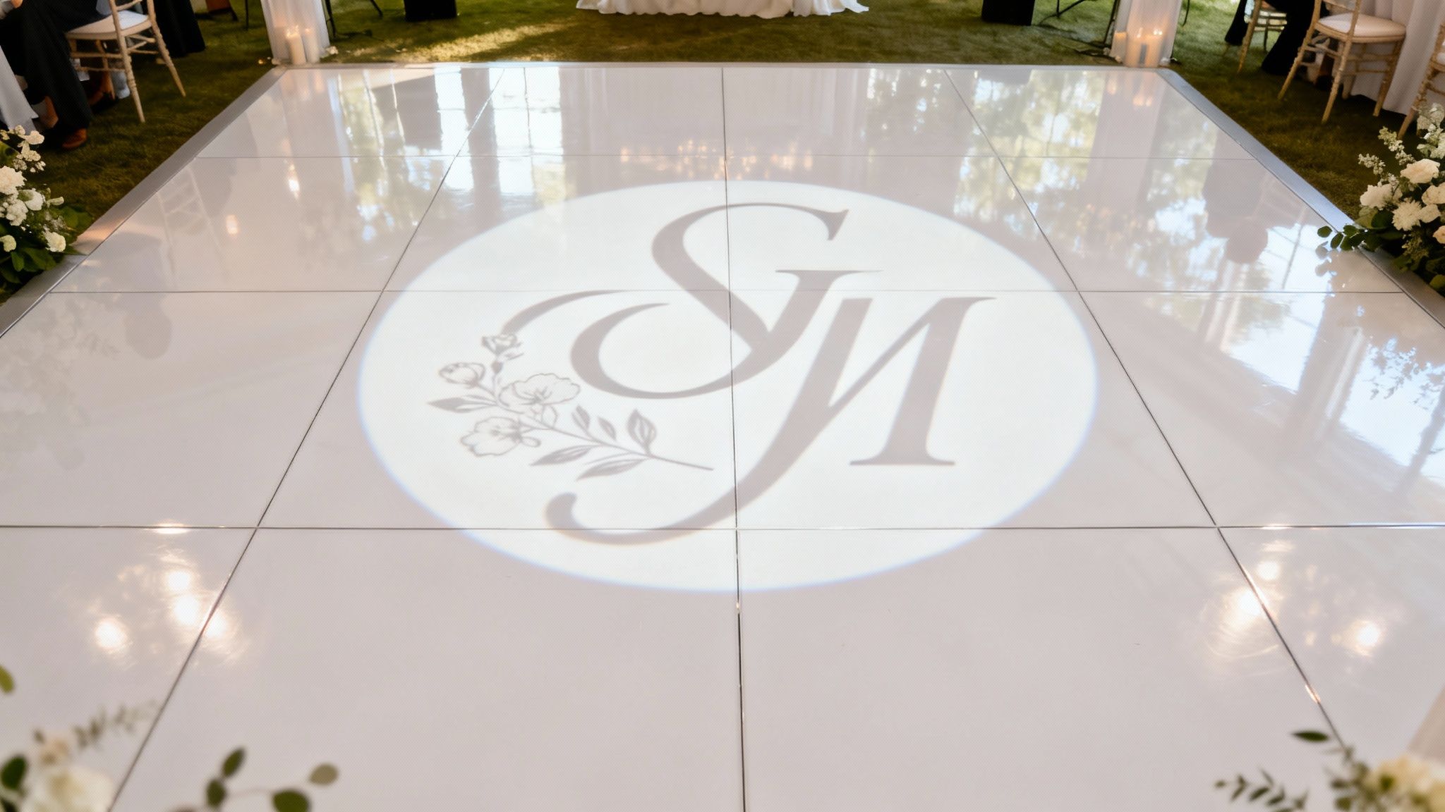 A beautiful monogram light projection on a wedding dance floor.
