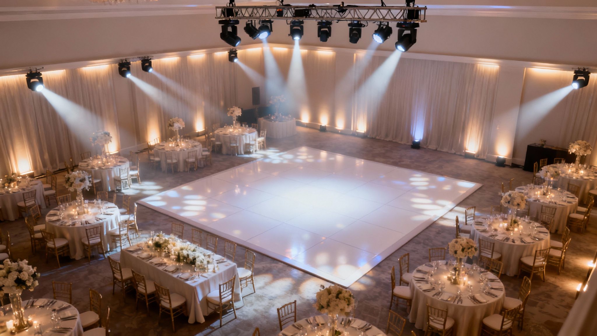 A wedding dance floor filled with guests, illuminated by dramatic blue and purple DJ lights for the wedding reception party.