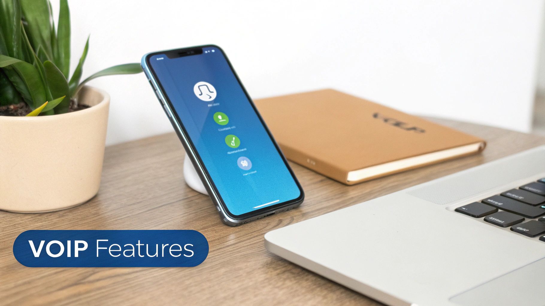 A smartphone displays a VoIP app on a desk with a plant, notebook, and laptop, highlighting VoIP features.