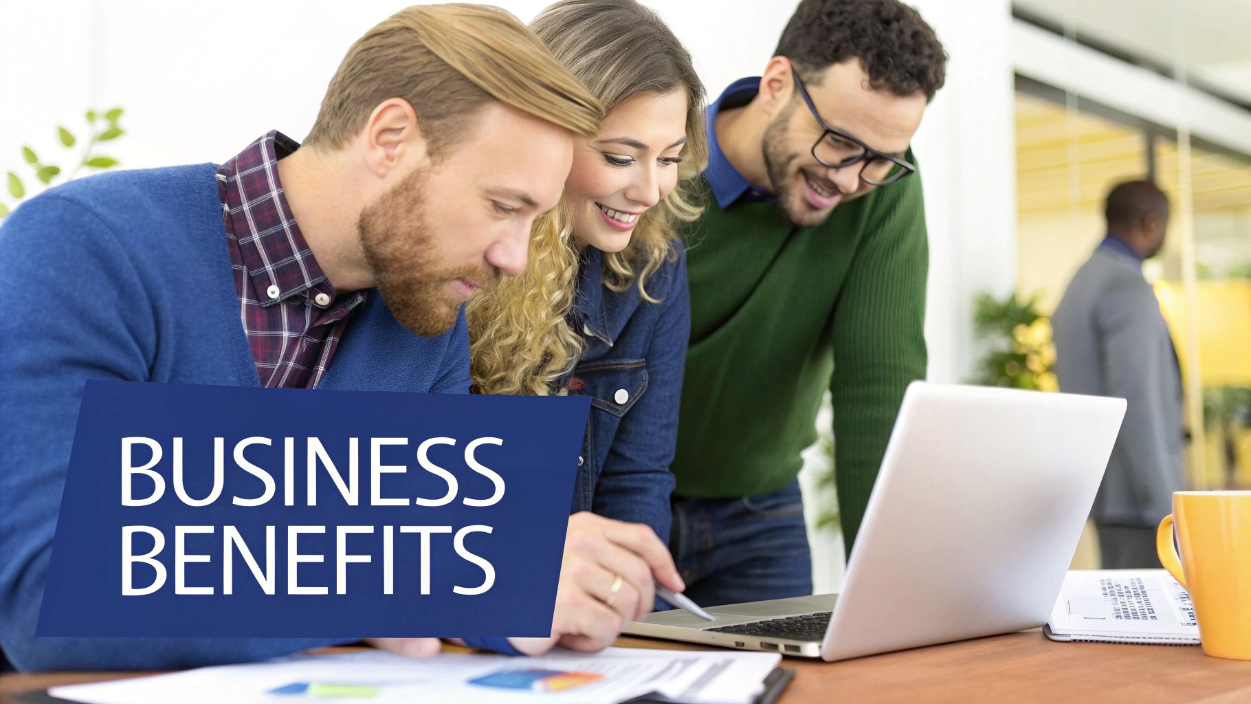 Three diverse business professionals collaborating on a laptop, discussing business benefits in an office setting.