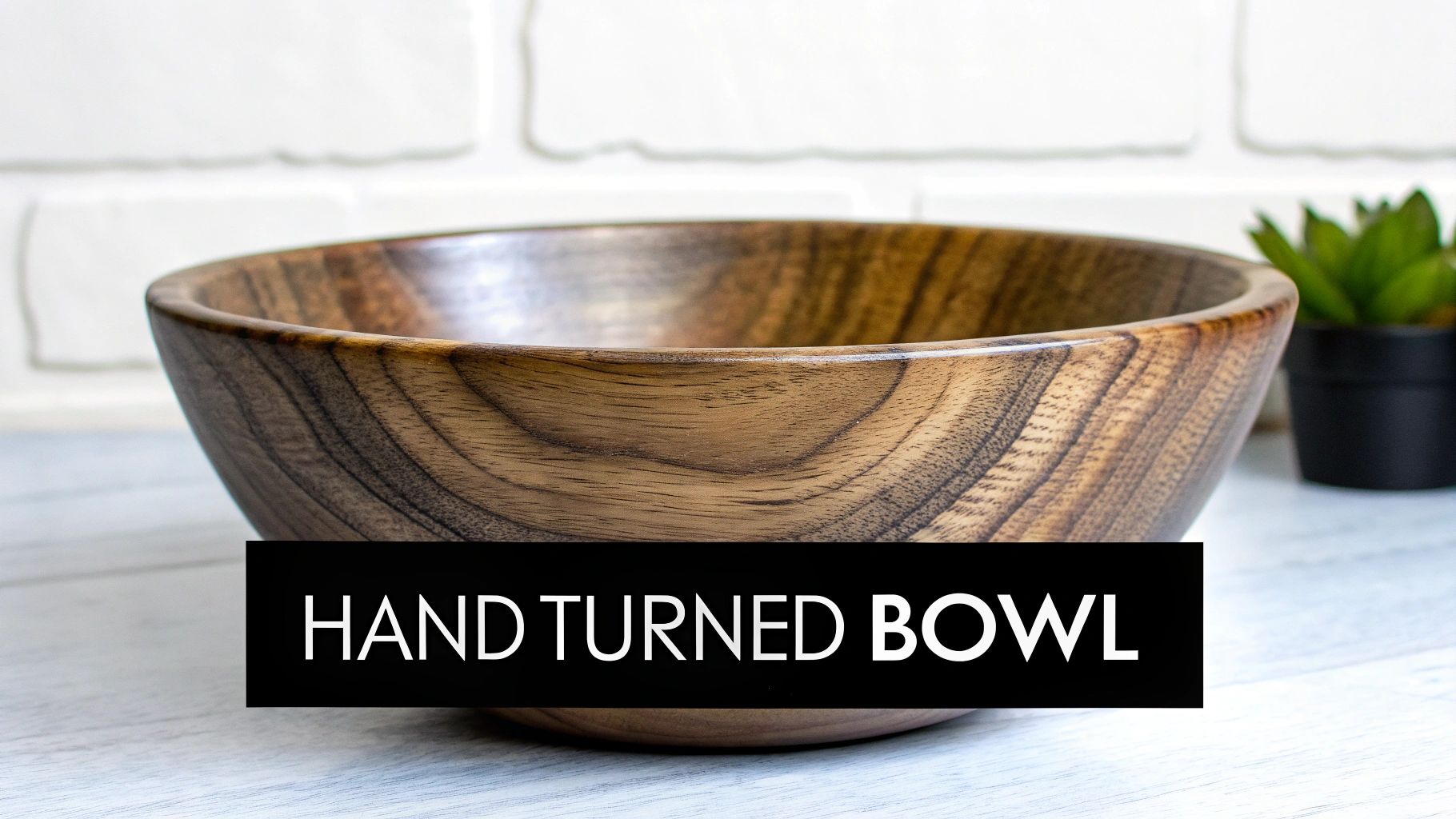 A beautifully crafted hand-turned wooden bowl with natural grain sits on a table.