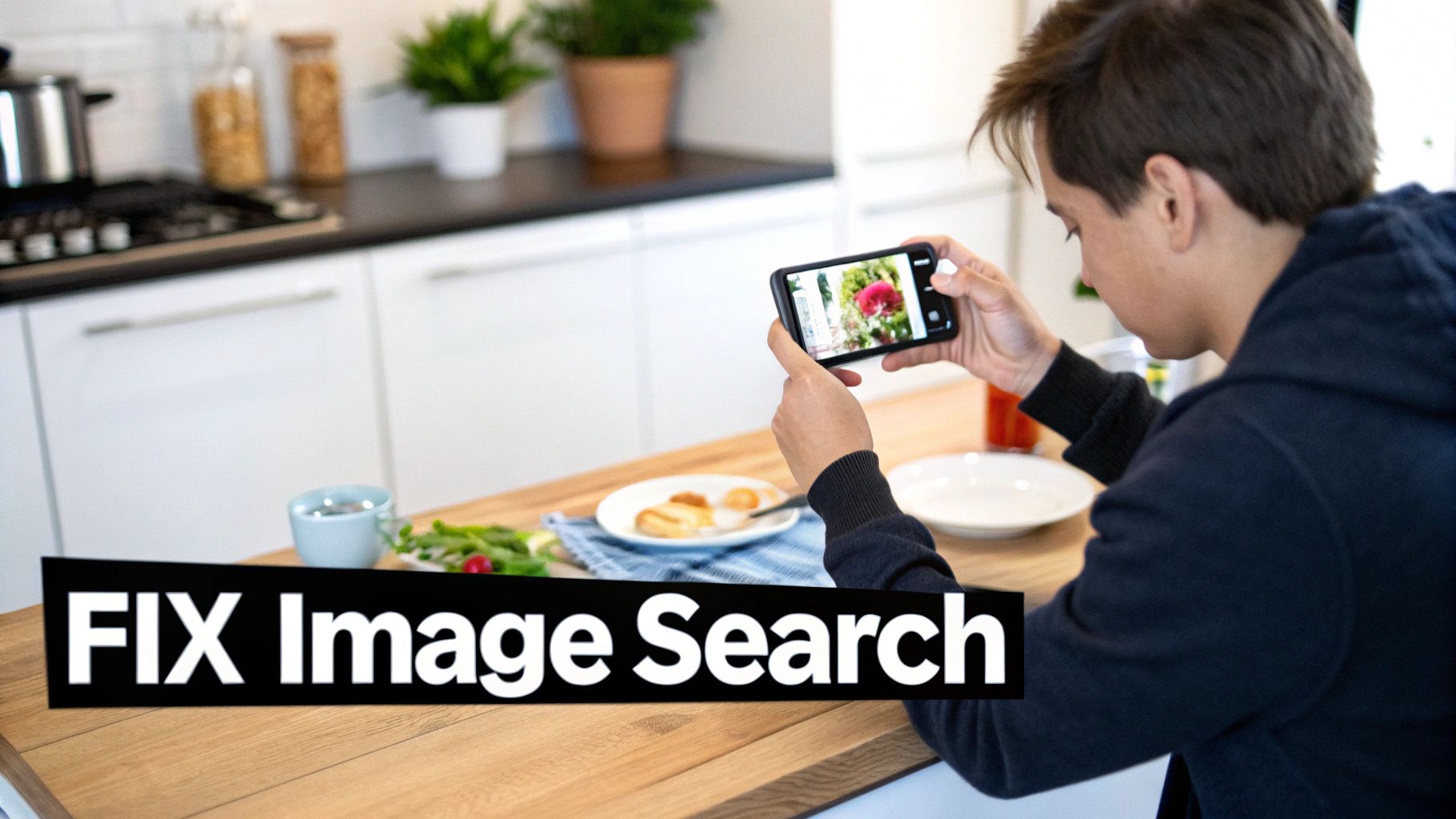 A person takes a photo of food on a wooden table with a smartphone in a modern kitchen.