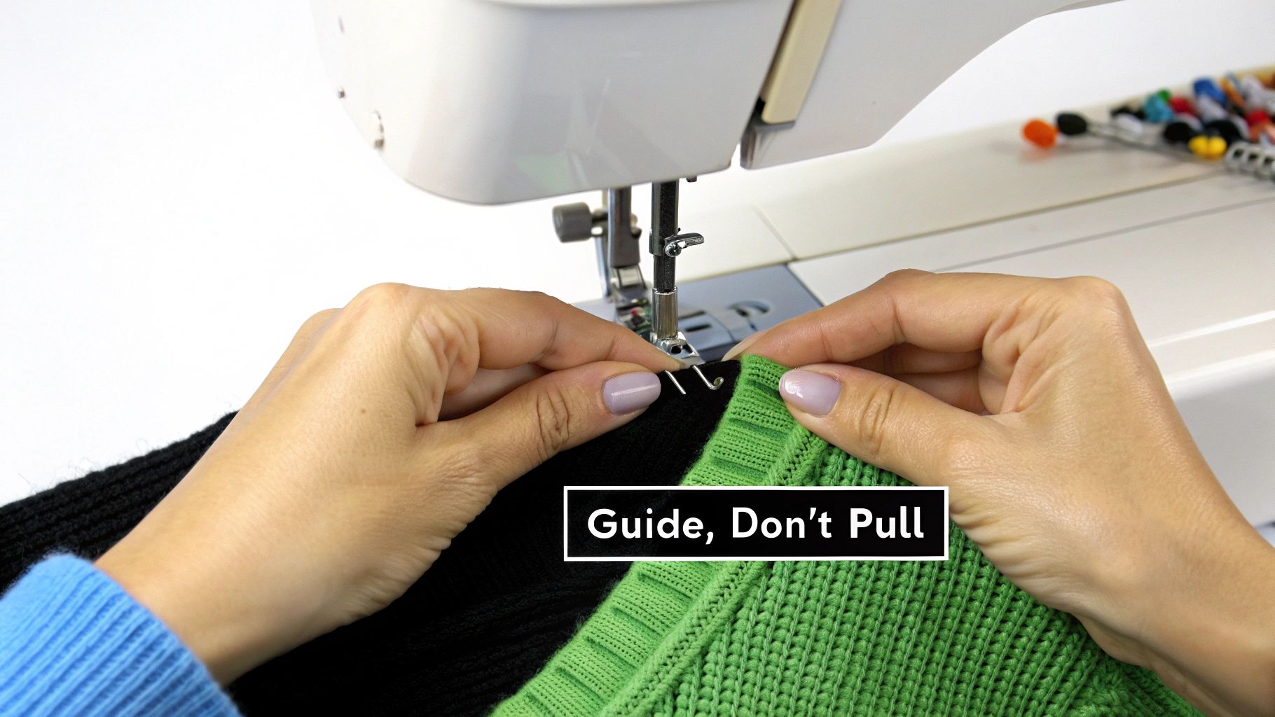 A close-up shot of a sewing machine needle sewing a seam on a piece of stretch fabric.