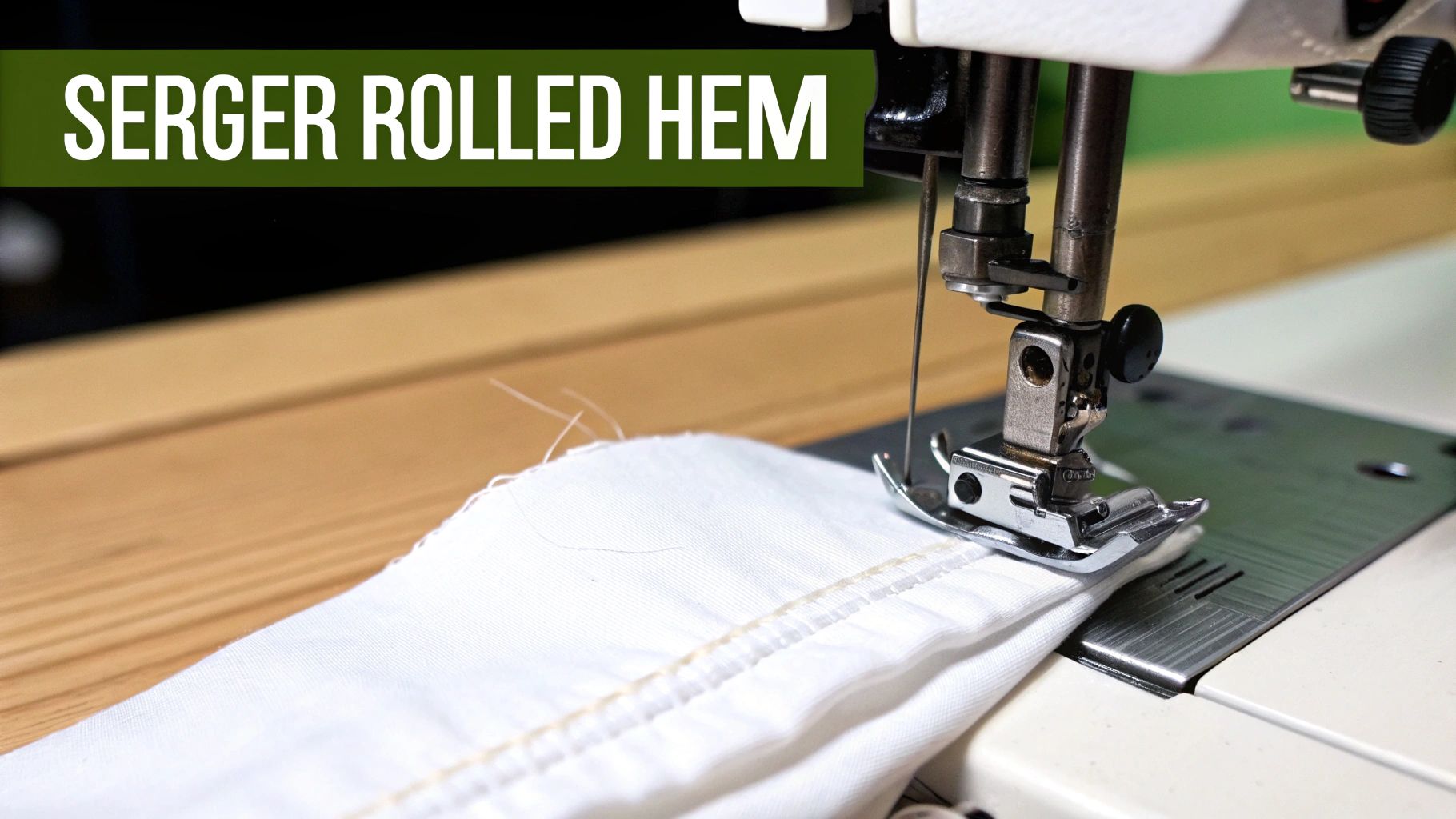 Close-up of a serger machine sewing a delicate rolled hem on white fabric, demonstrating sewing technique.
