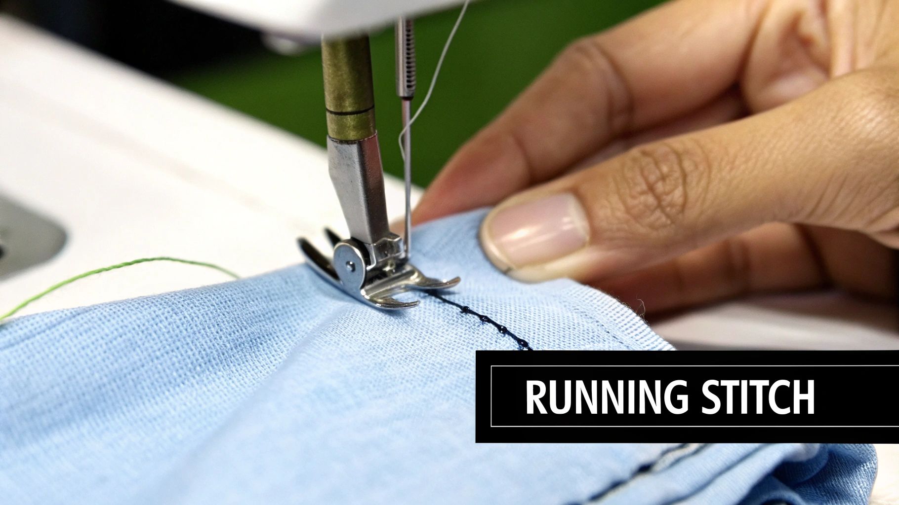 Close-up of a sewing machine creating a running stitch on light blue fabric, guided by a hand.