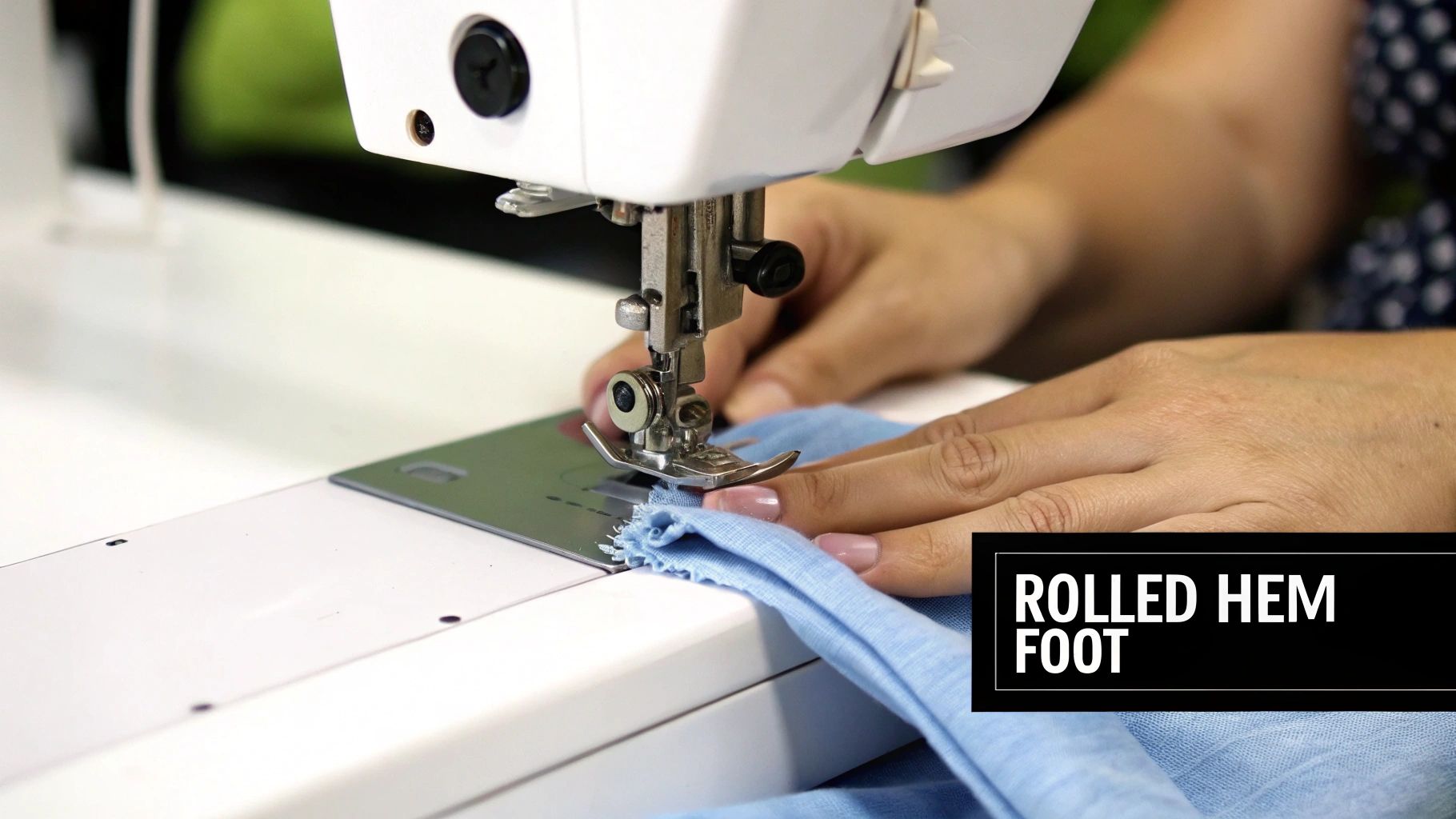 A person's hands guiding light blue fabric through a sewing machine with a rolled hem foot.