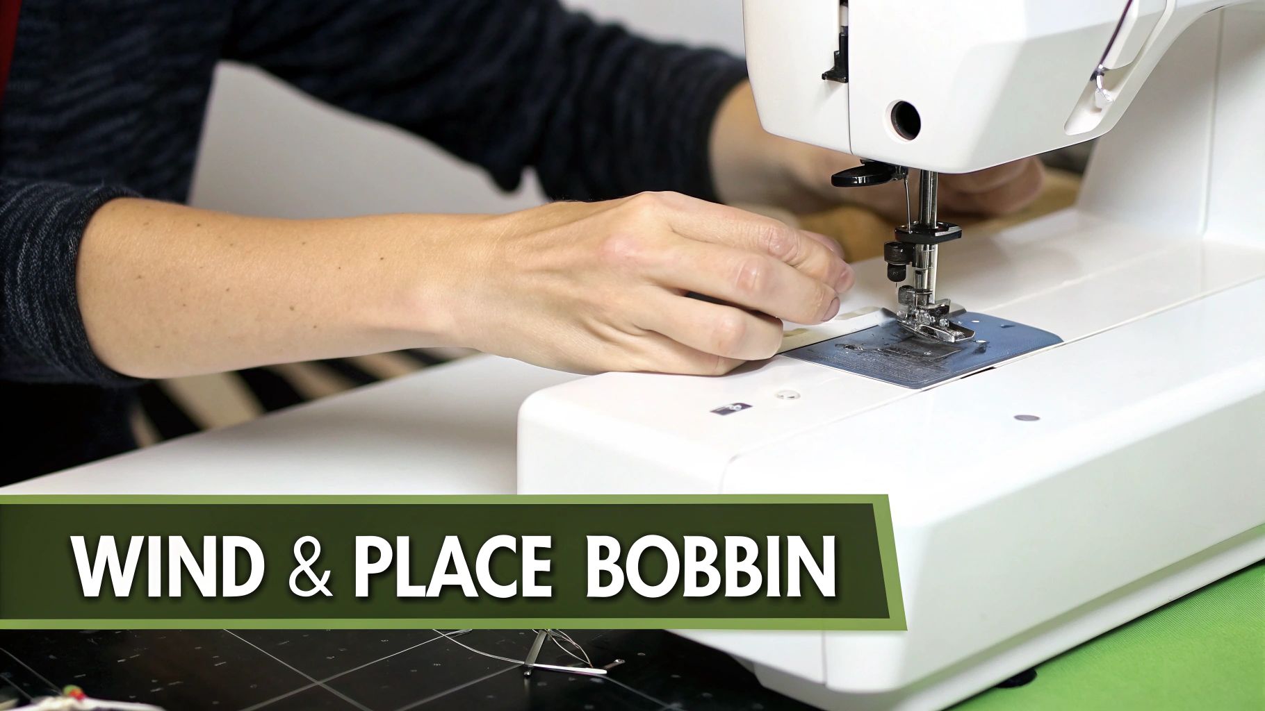 Hands guide fabric under the needle of a white sewing machine, preparing to wind and place the bobbin.