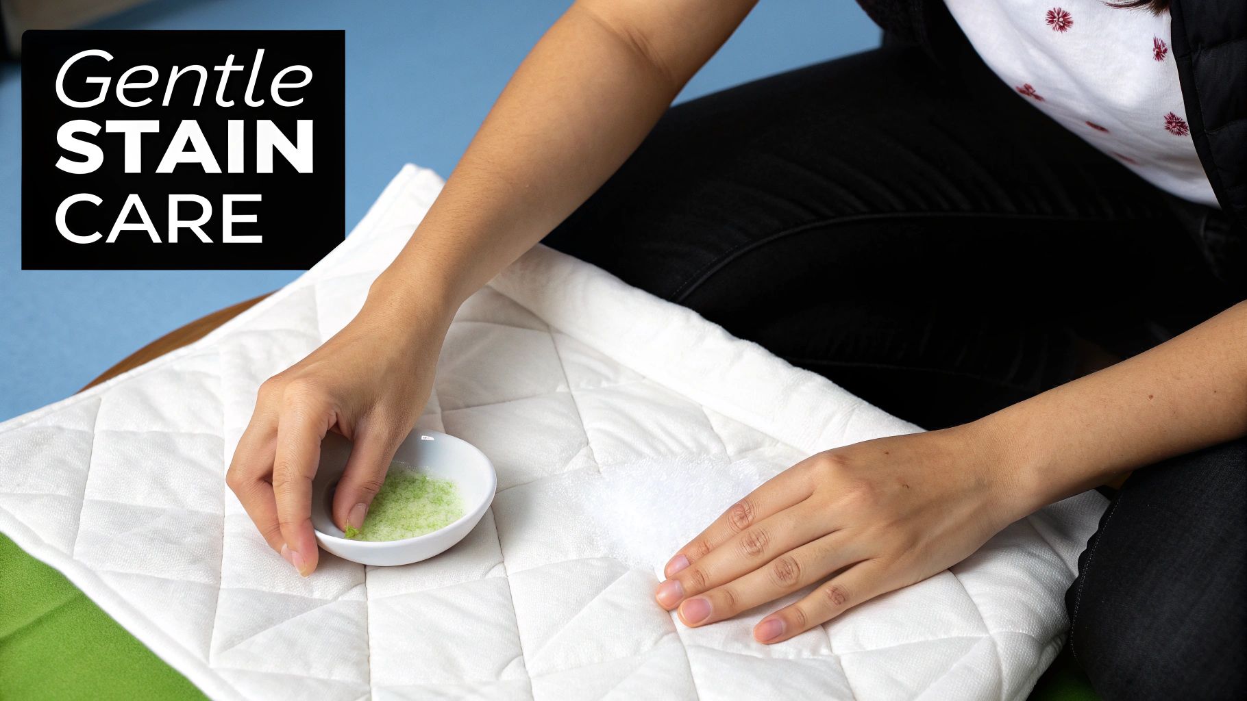 Hands applying green cleaning granules to a stain on a white quilted fabric, labeled "Gentle STAIN CARE".