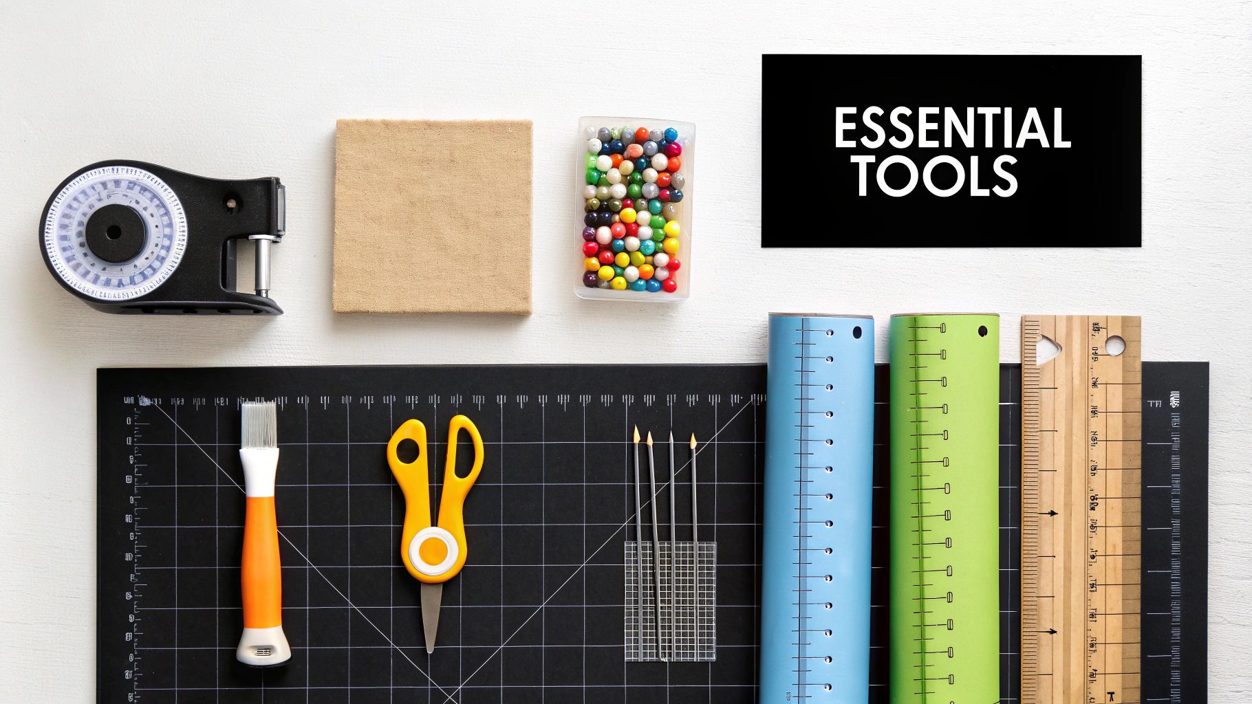 A flat lay displaying various essential quilting and crafting tools on a white background.