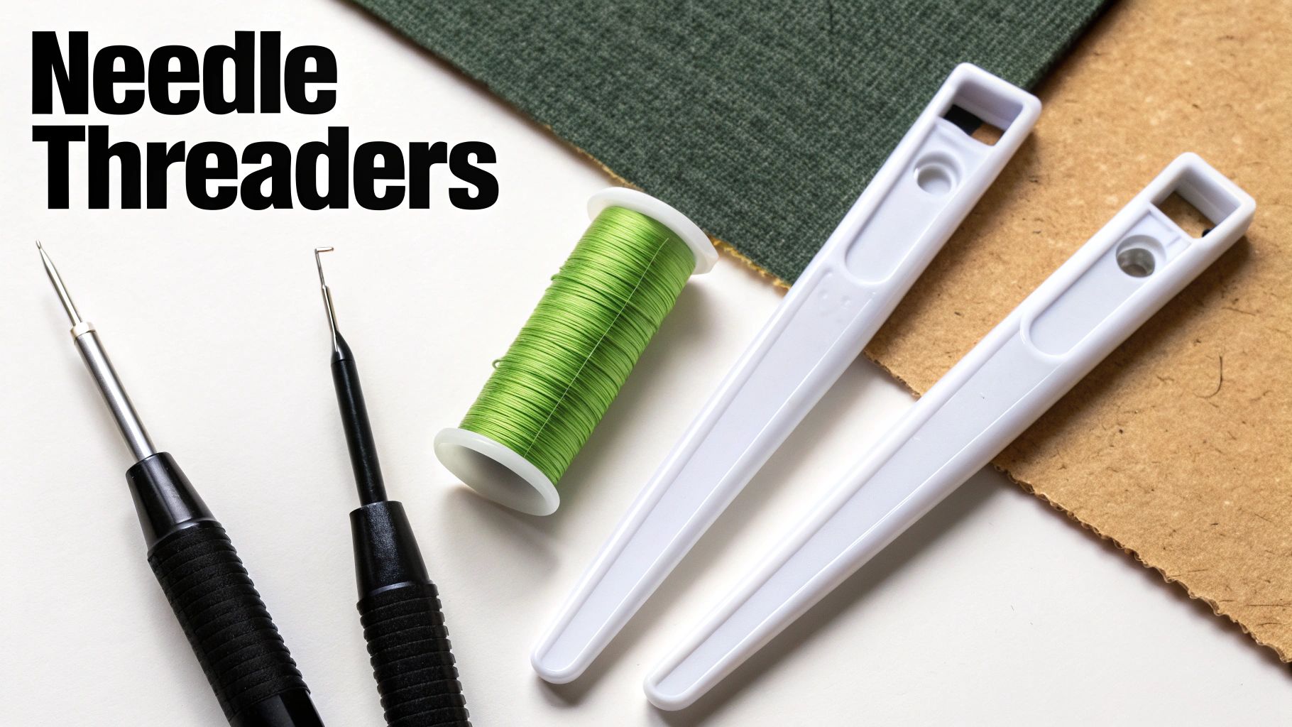 Close-up of various needle threaders, a spool of green thread, and fabric samples.
