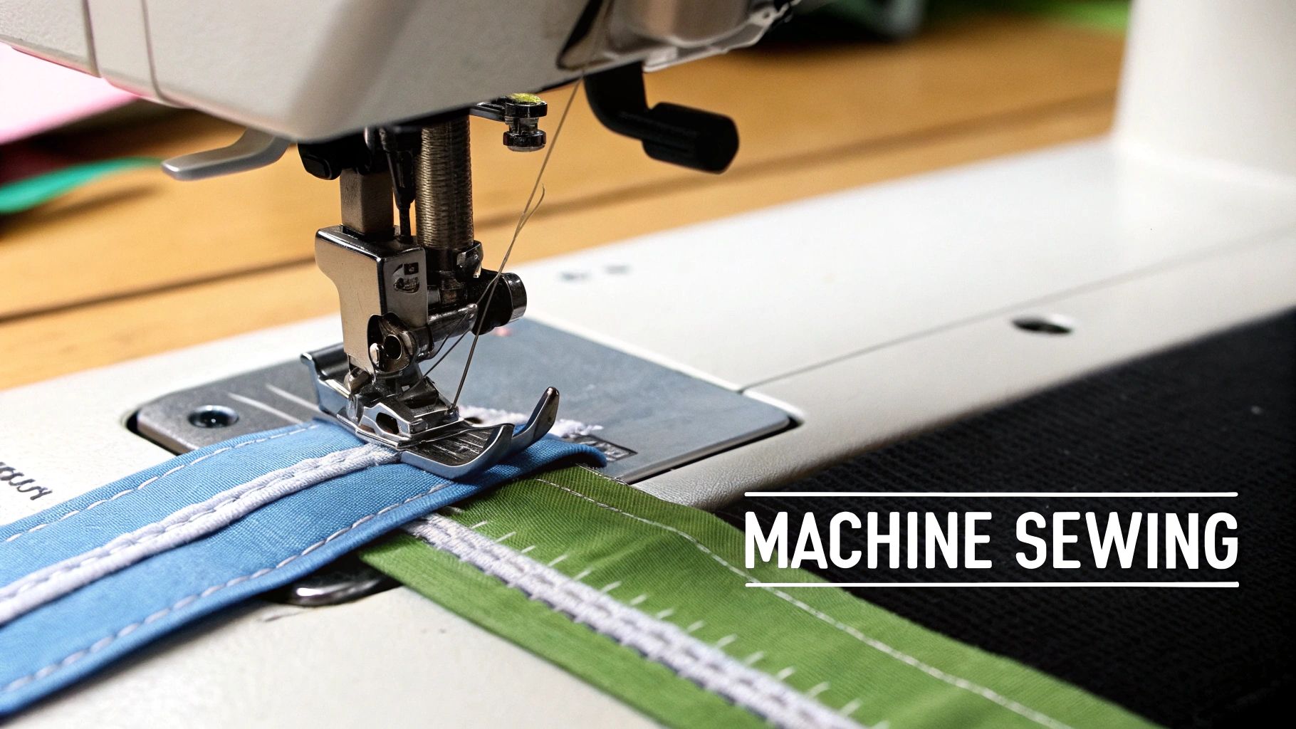 A close-up of a sewing machine stitching blue and green fabric with white thread.