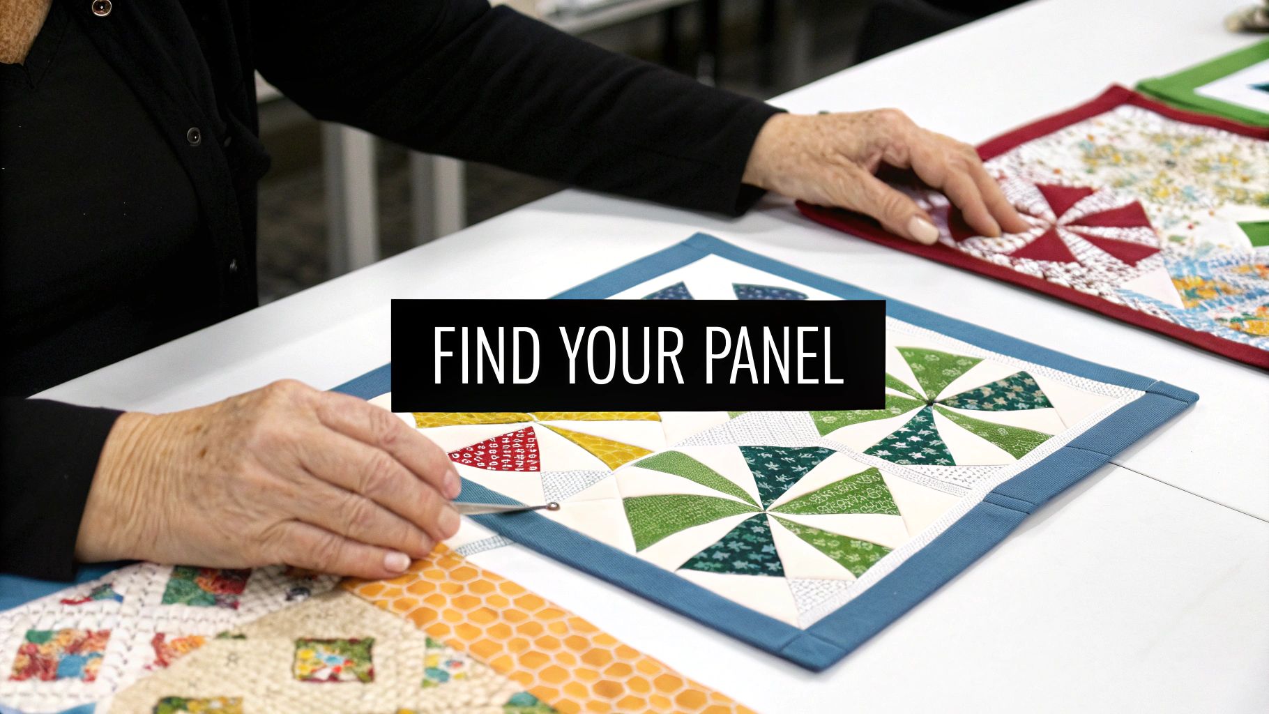 Close-up of a person's hands crafting colorful fabric quilt panels with intricate patterns.