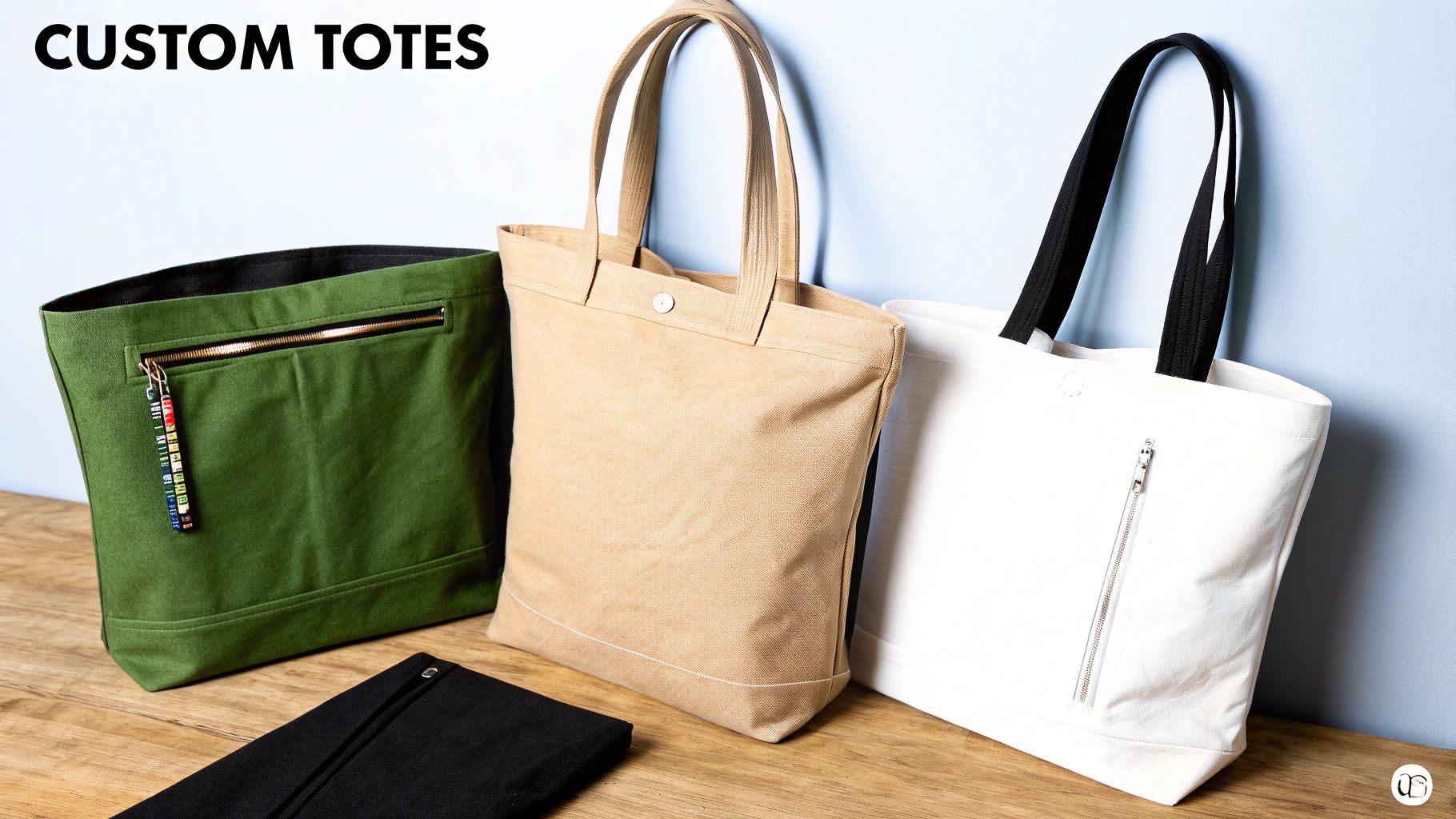 Three custom canvas tote bags in green, tan, and white with different zipper and snap features.