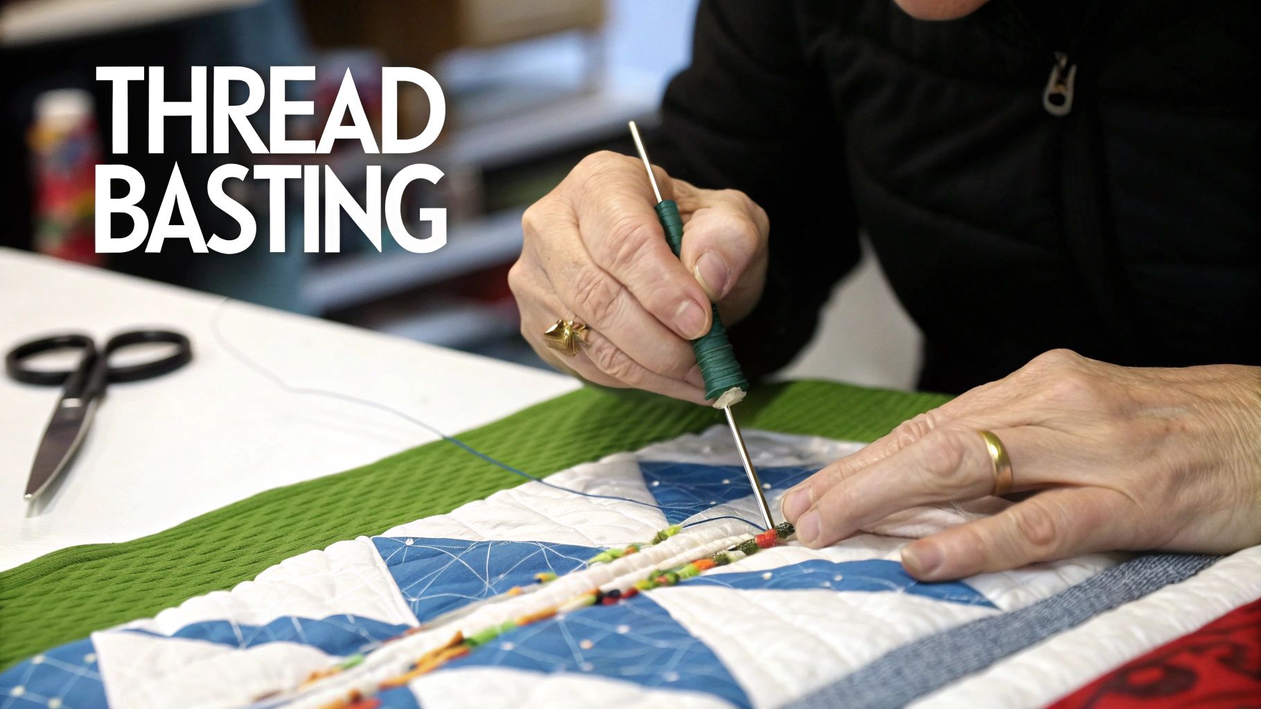 Quilter's hands using thread basting tool to secure colorful patchwork quilt layers together