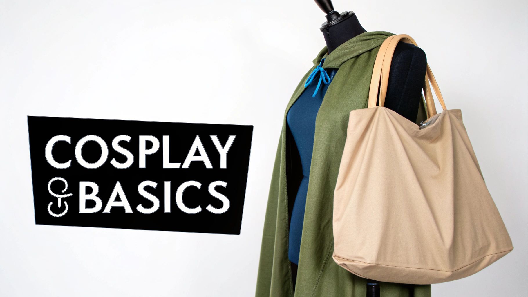 A mannequin wears a green cape, blue garment, and holds a beige tote bag next to a 'COSPLAY & BASICS' sign.