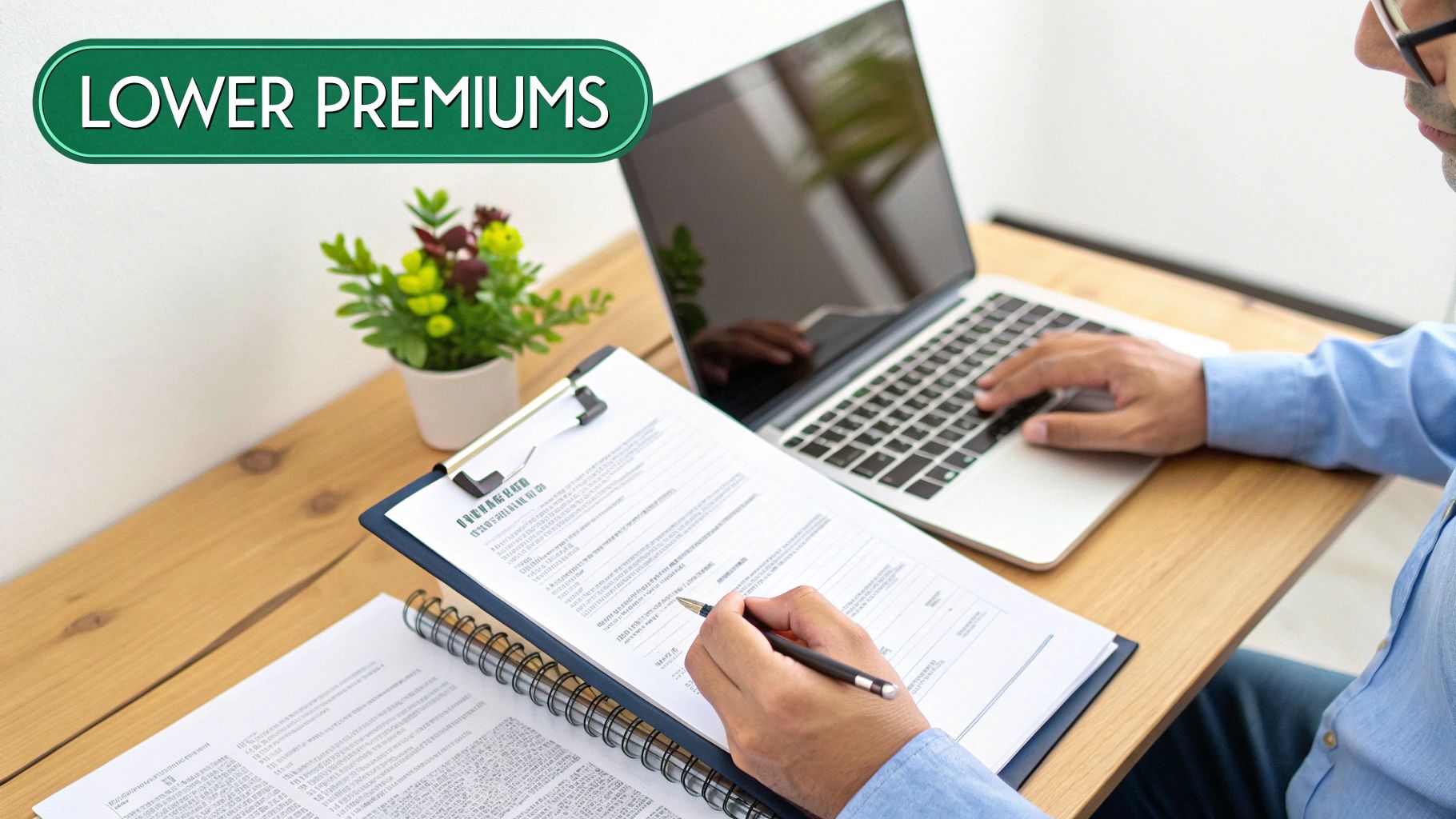 Professional working on laptop reviewing insurance documents with lower premiums label on desk