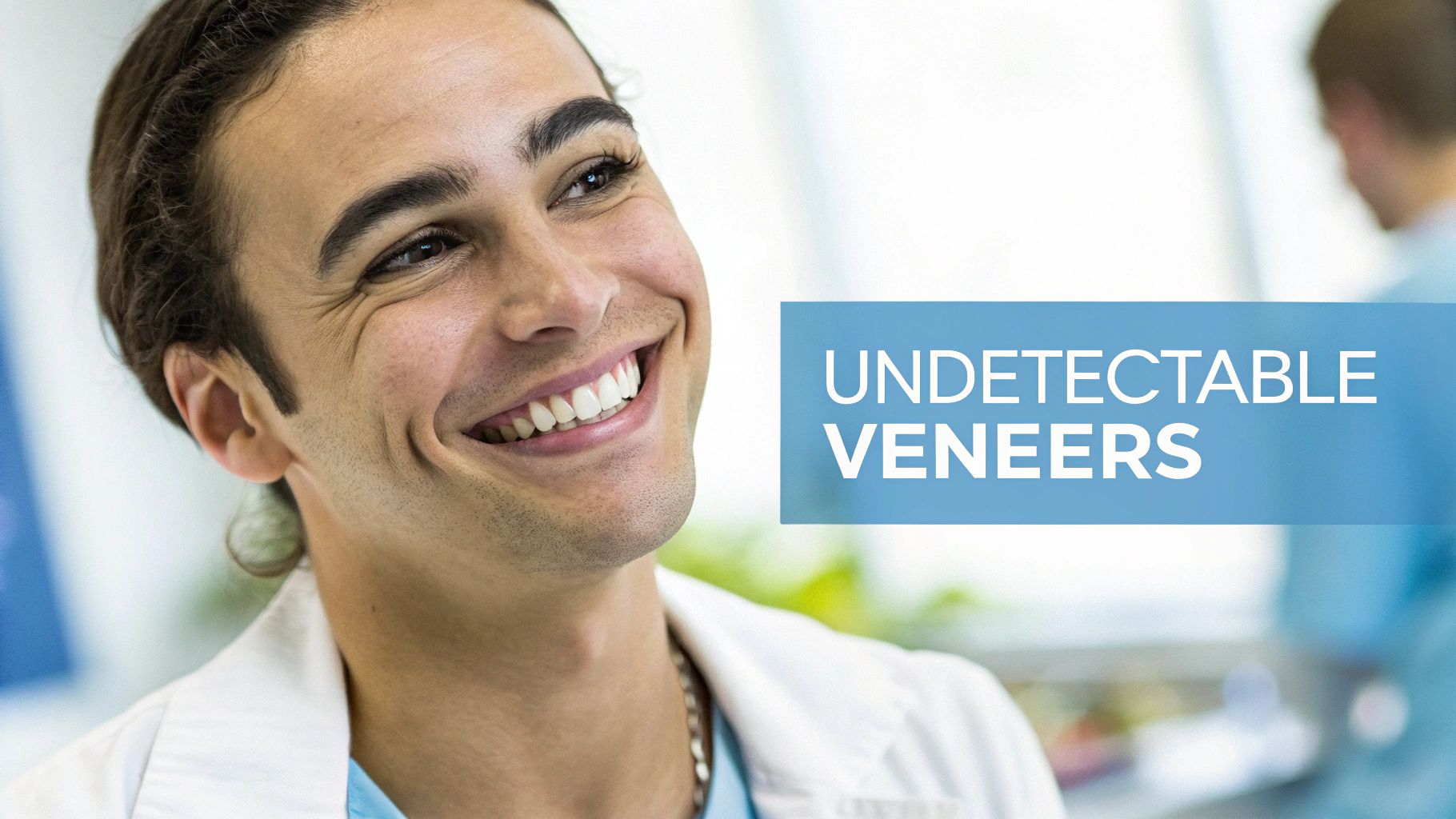 A young man with a bright, natural smile, highlighting the effectiveness of undetectable veneers.
