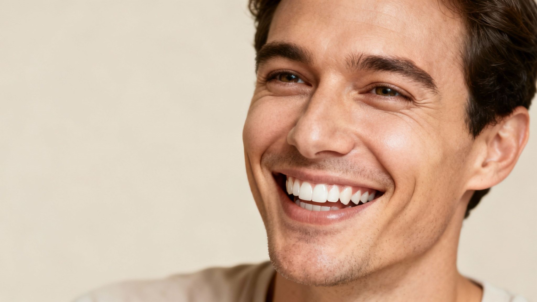 Close-up of a happy man with a bright white smile and healthy teeth.