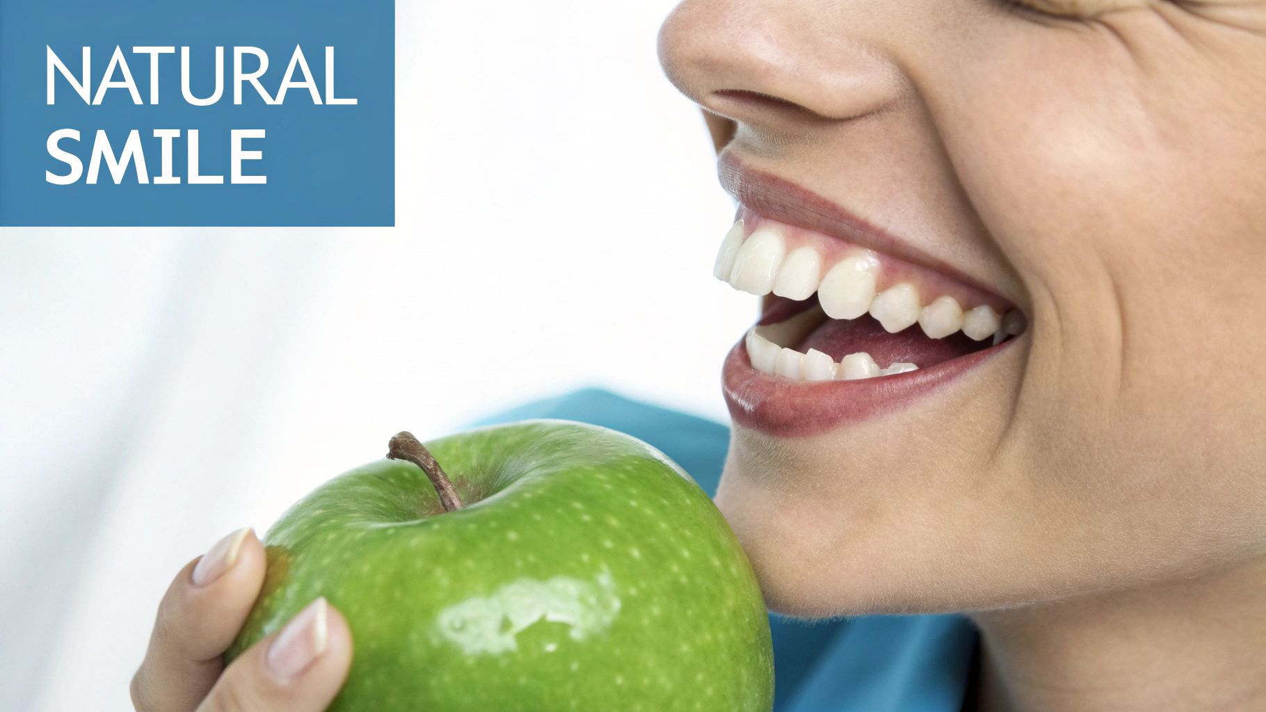 A smiling person with bright, healthy teeth holds a green apple, promoting natural dental health.