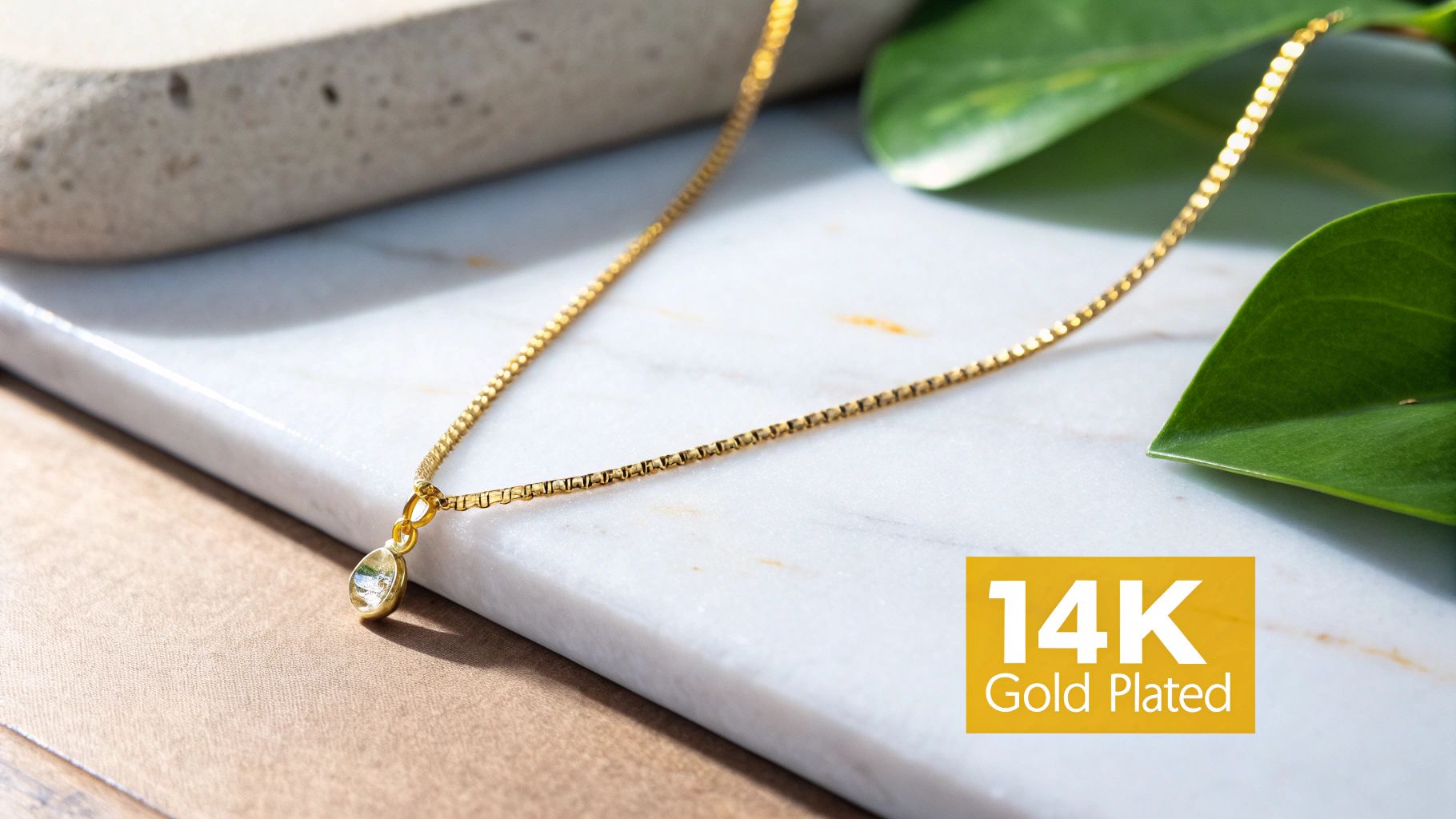 A close-up of a 14k gold plated necklace chain showing its texture and shine.