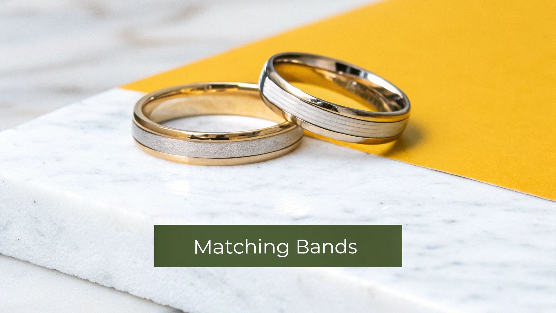A stylish couple holding hands, showcasing their wedding bands.