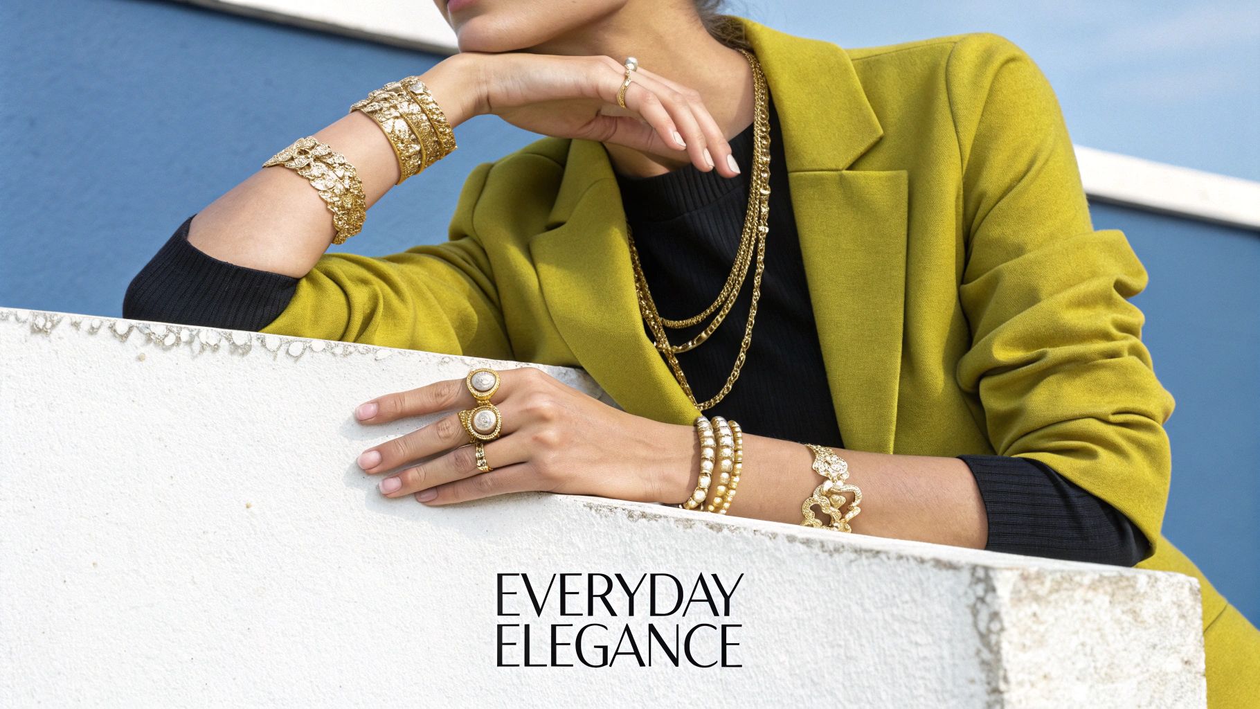 A model showcasing elegant vermeil earrings and a necklace.