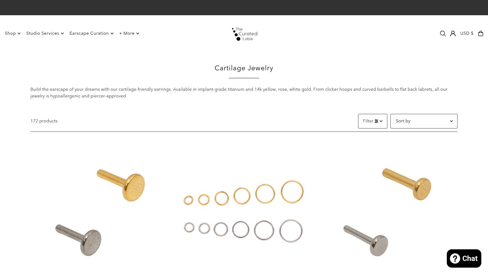 A screenshot of The Curated Lobe website showcasing their collection of high-quality cartilage earrings.