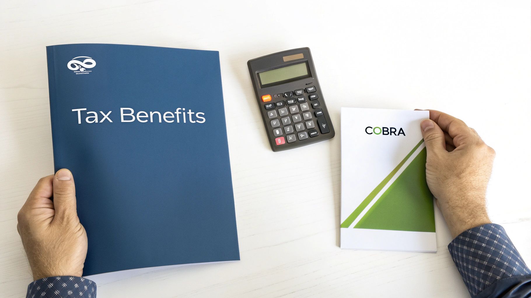 Hands holding a 'Tax Benefits' folder and a 'COBRA' booklet, with a calculator on a white desk.