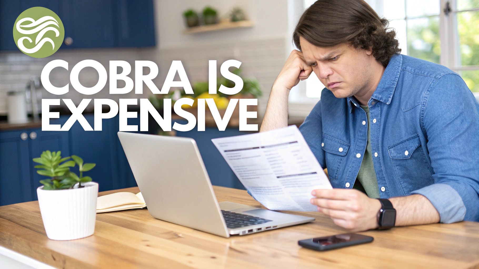 Stressed man reviewing a document about COBRA insurance expenses on a wooden table with a laptop.