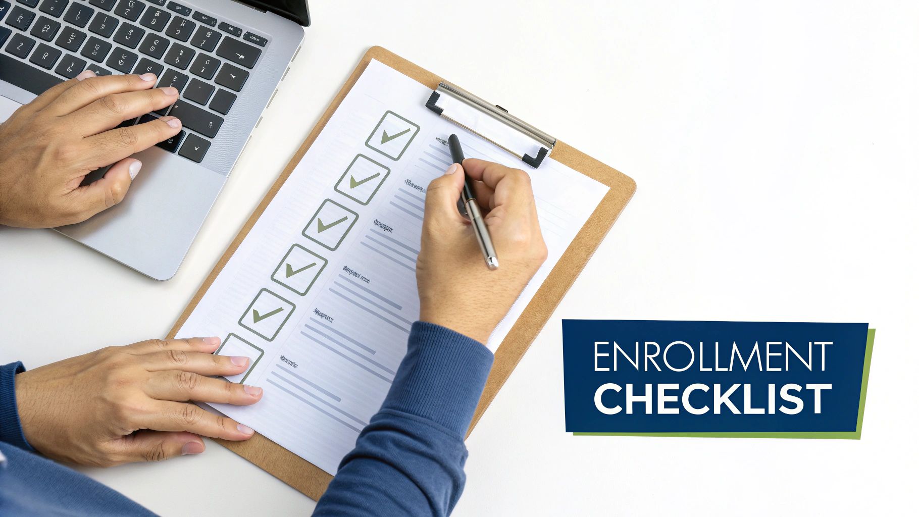 An overhead view of hands completing an enrollment checklist on a clipboard next to a laptop.