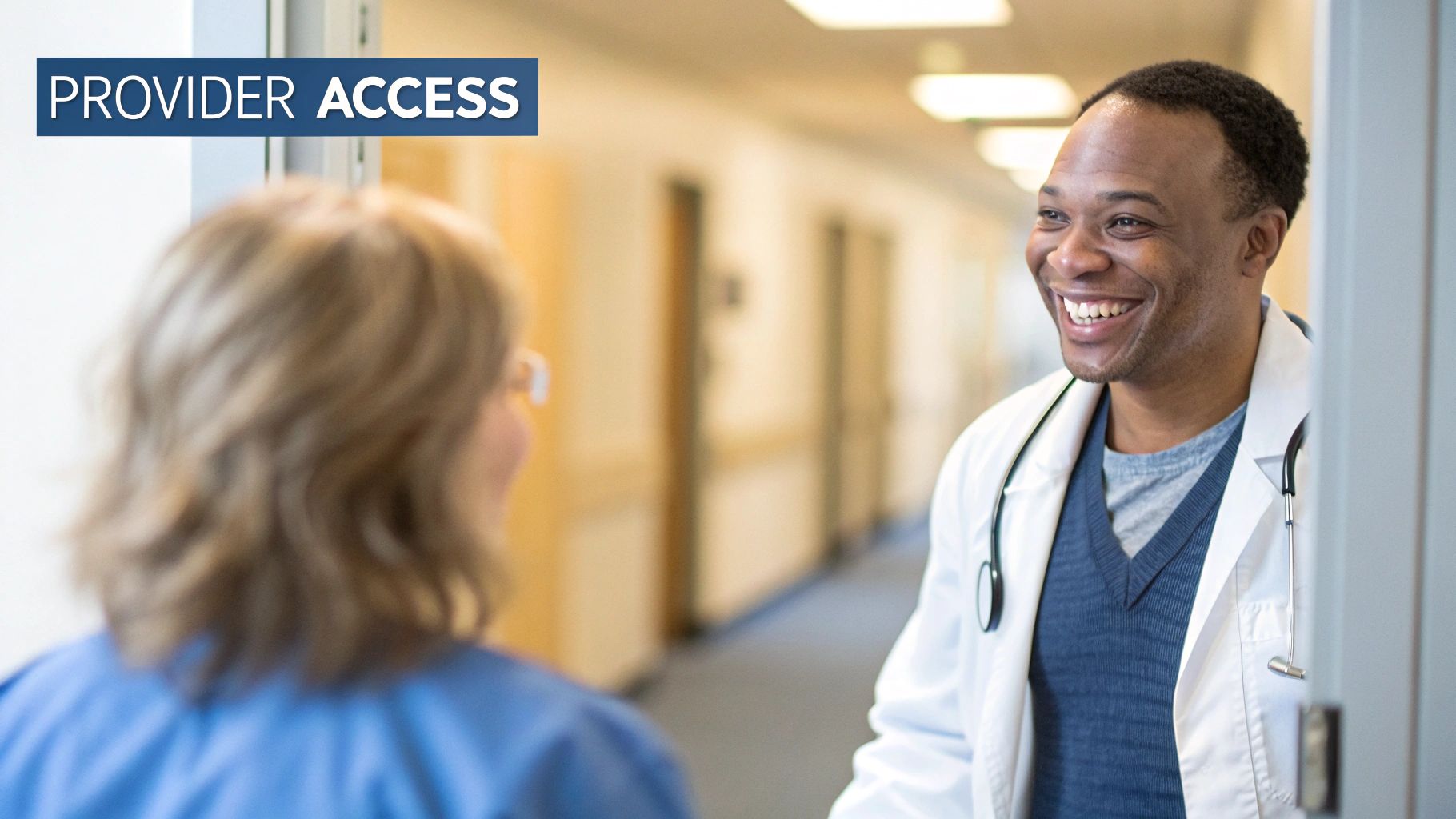 Smiling male doctor with a stethoscope and 'Provider Access' text in a hospital hallway.
