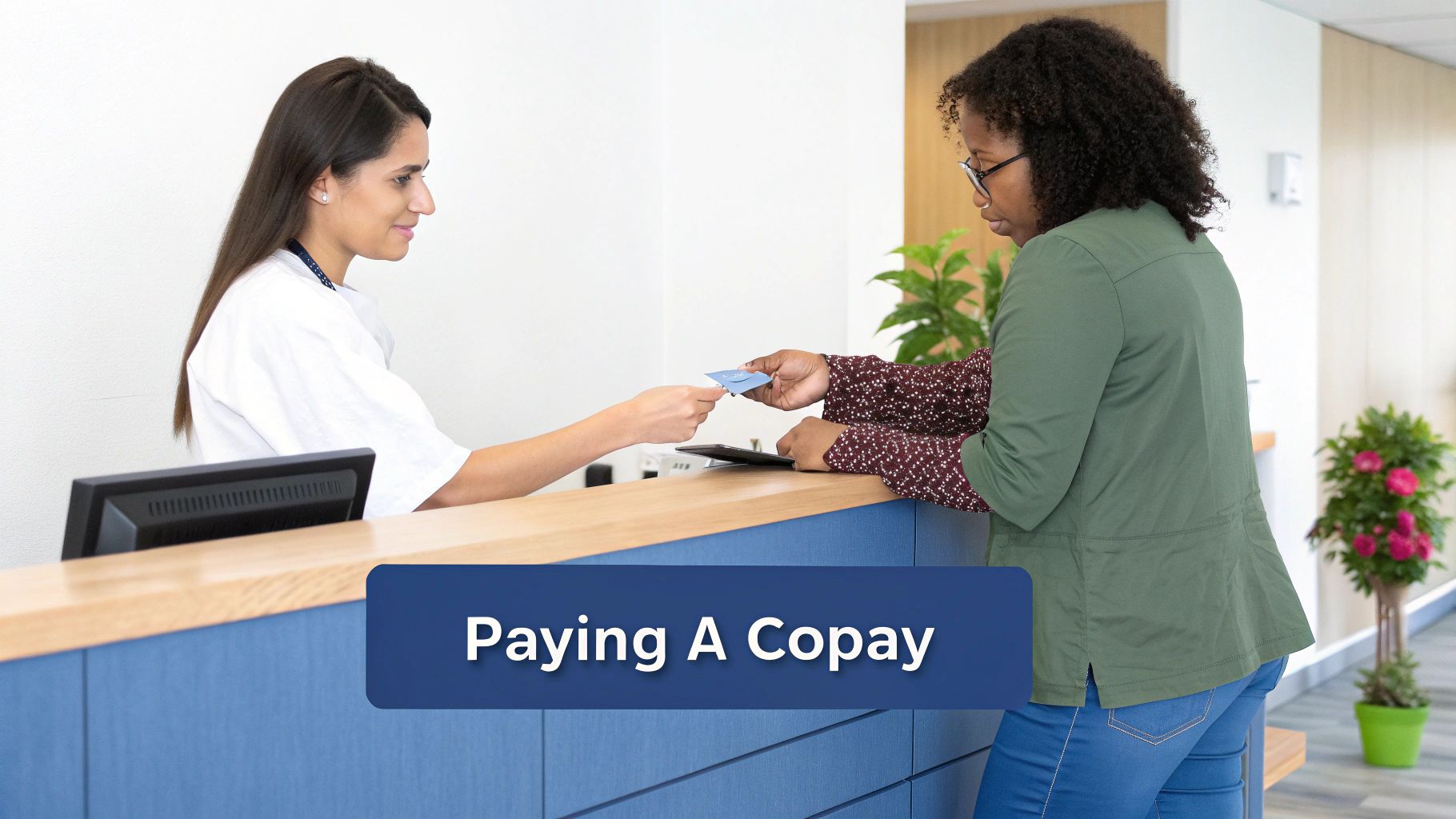 A person paying at a medical reception desk.