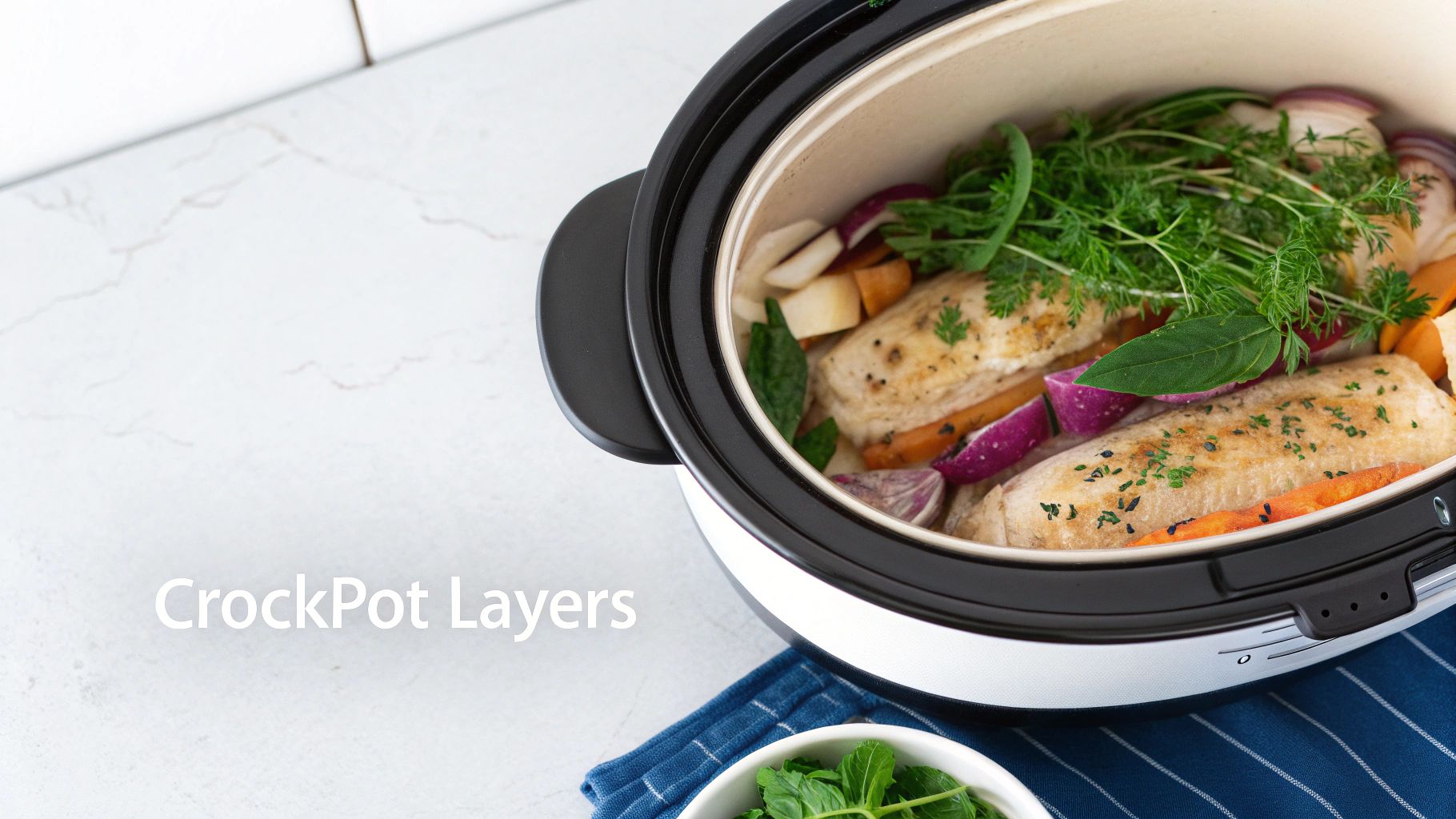 A crockpot filled with chicken, carrots, red onions, root vegetables, and fresh herbs.