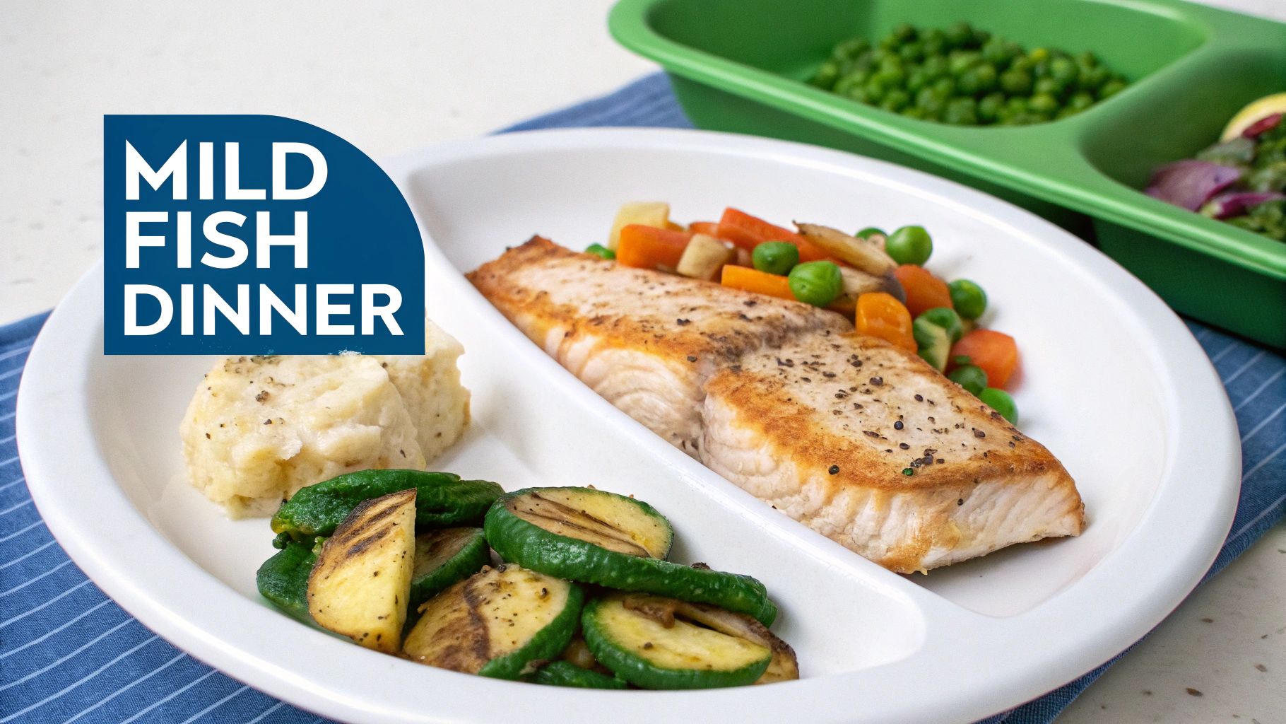 A mild fish dinner served on a divided plate with salmon, mashed potatoes, and roasted vegetables.