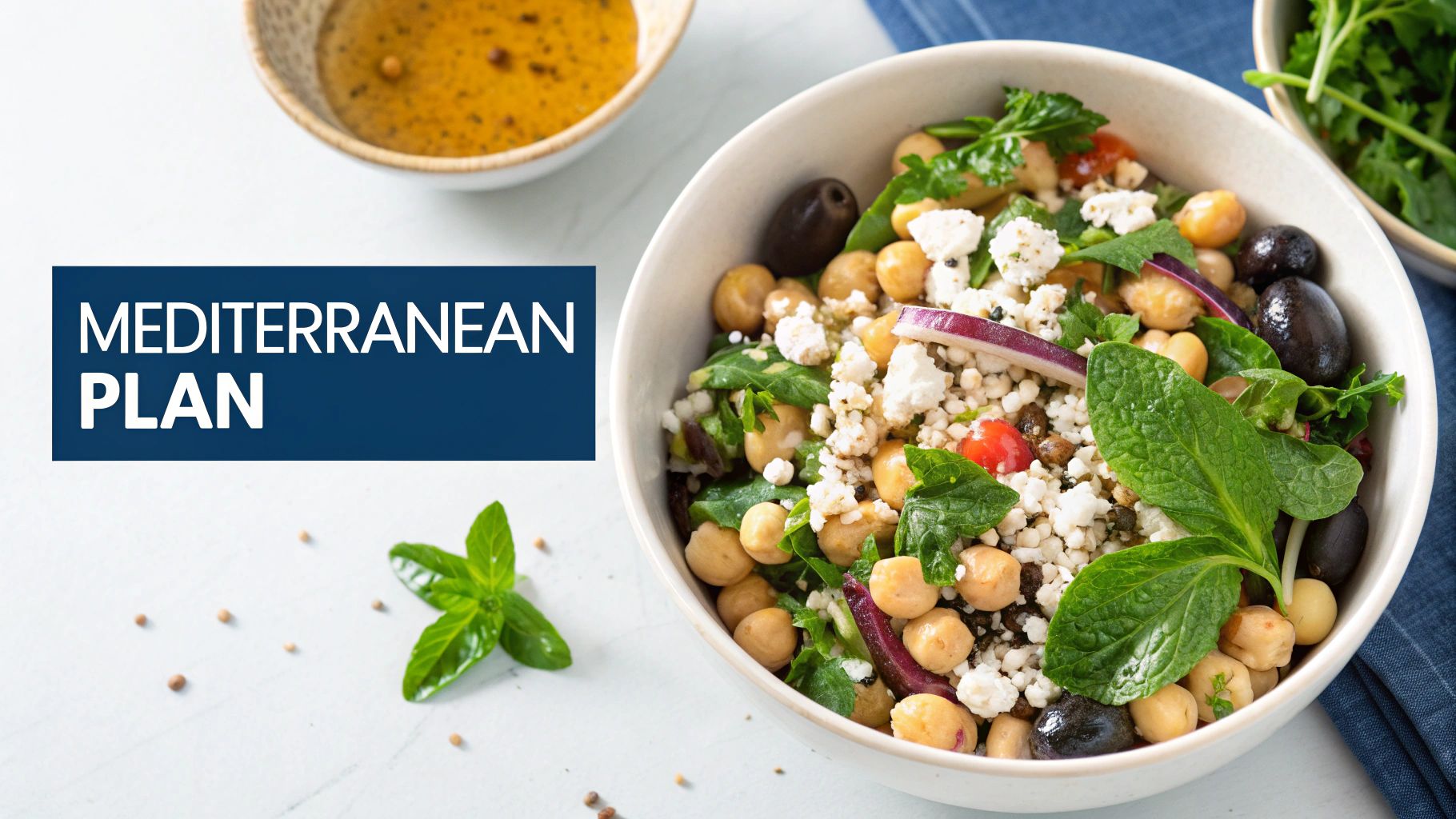 A vibrant Mediterranean salad with chickpeas, feta cheese, olives, and fresh mint, with a side of dressing.
